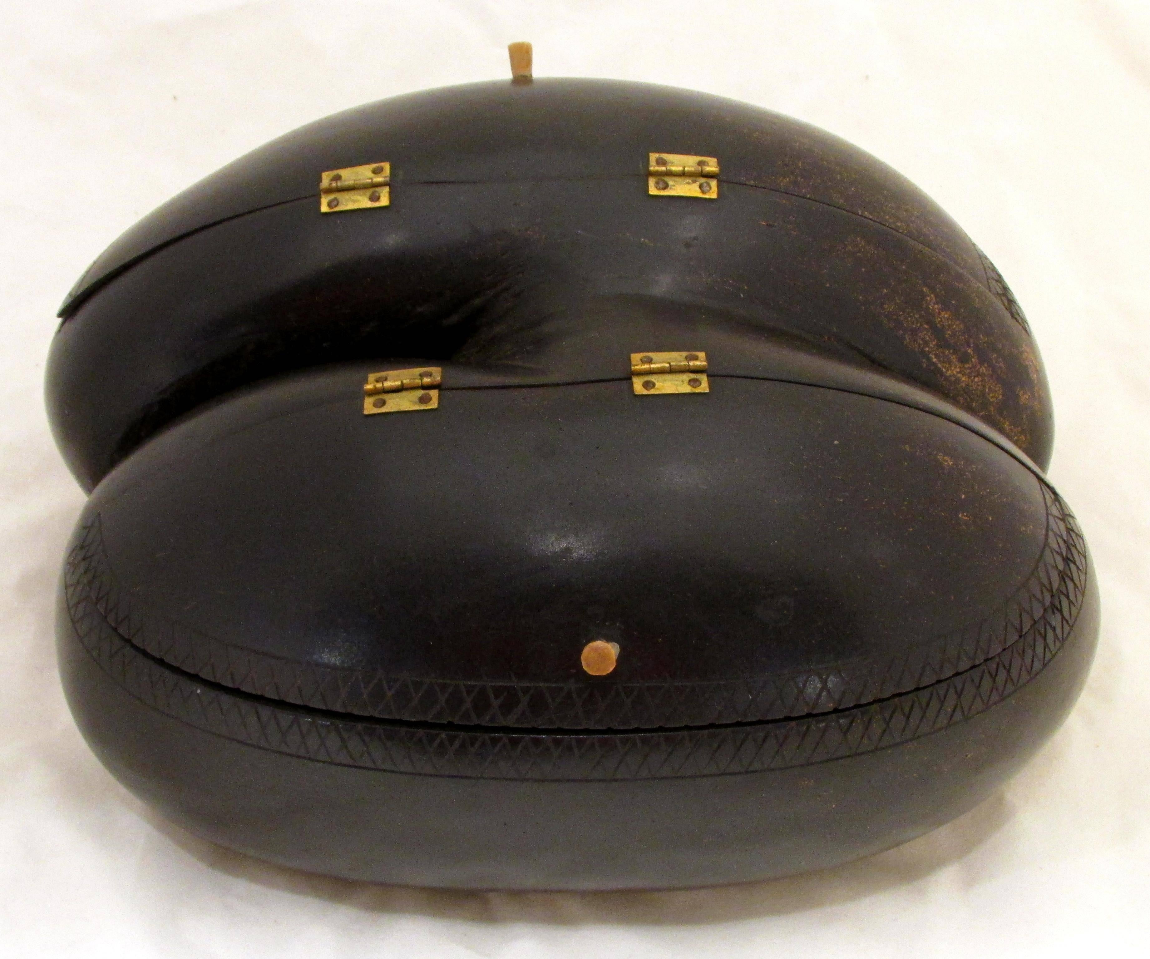 Rare Coco De Mer or double coconut which has been turned into a box with two brass hinged lid openings with small wooden handles coconut has some carving details.