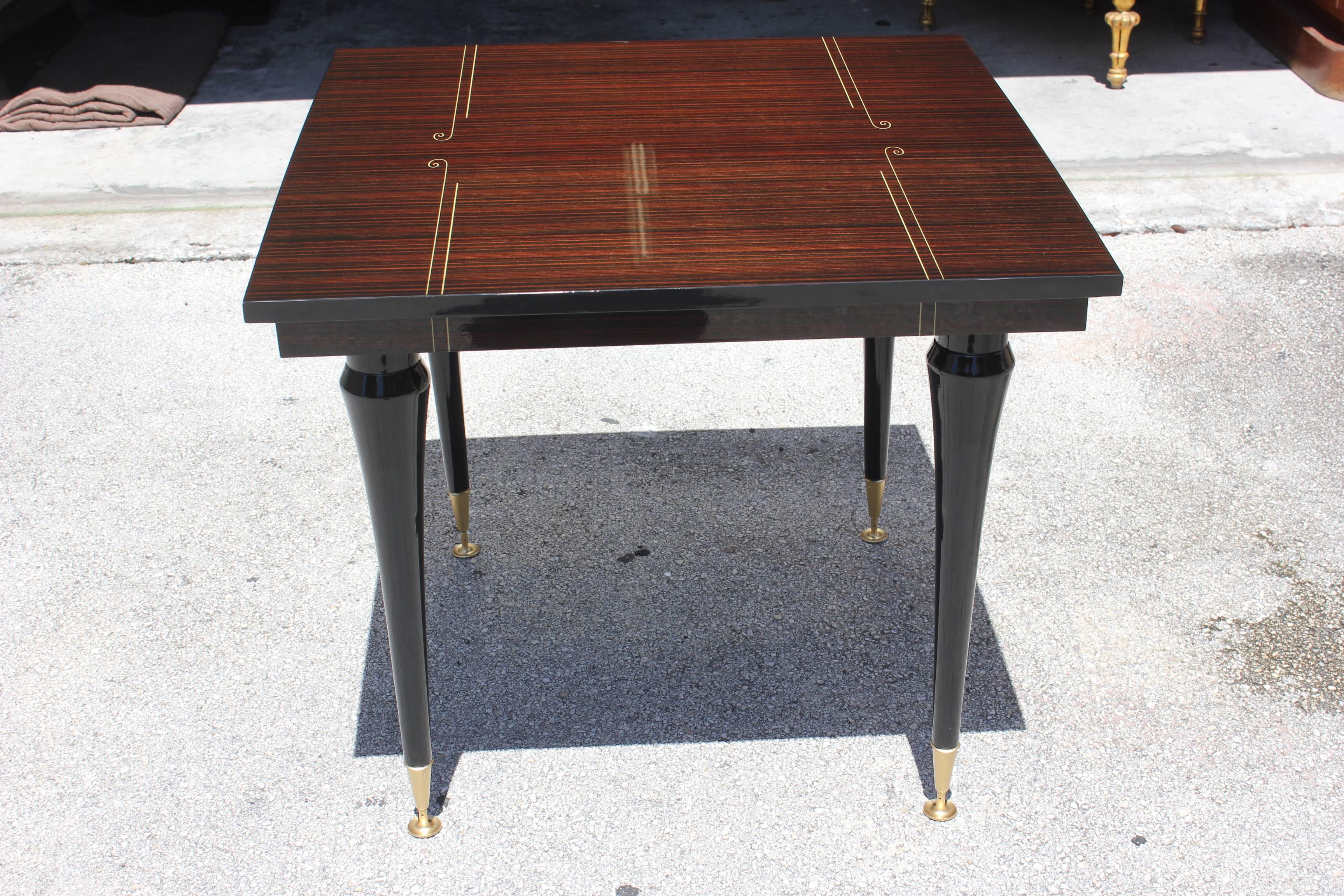 A detailed French Art Deco exotic Macassar ebony square center or Foyer table, circa 1940s. Stunning top and black lacquer legs.