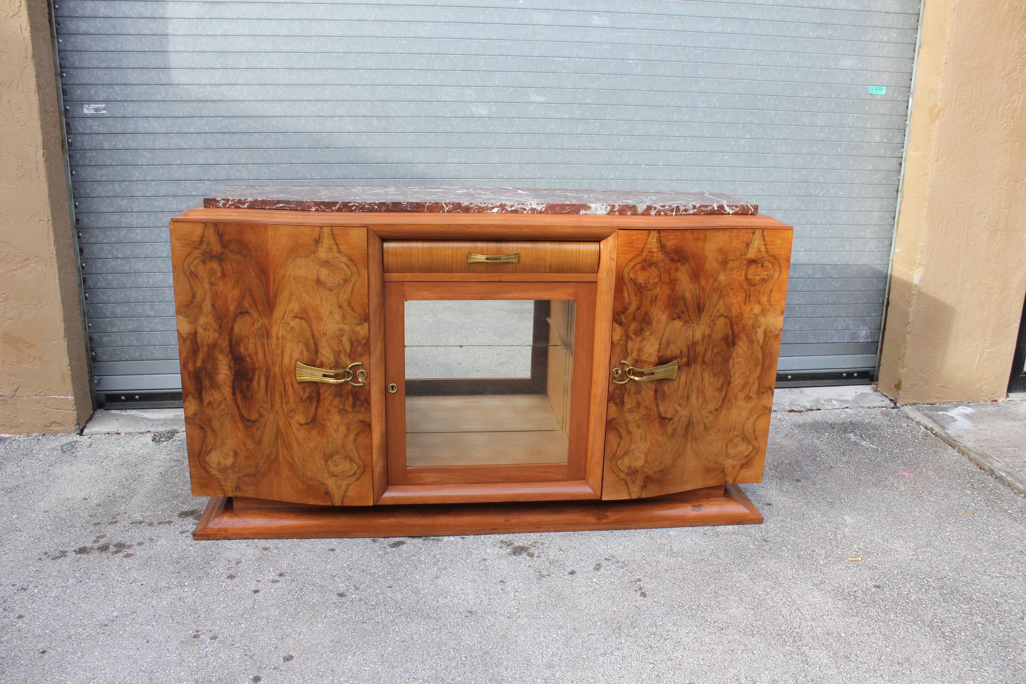 A Classic French Art Deco exotic walnut sideboard or buffet, circa 1930s. Marble-top, elaborate hardware, finished interior, all keys present, this piece is beautiful, central glass display cabinet,(with the original finish very good condition. )

 