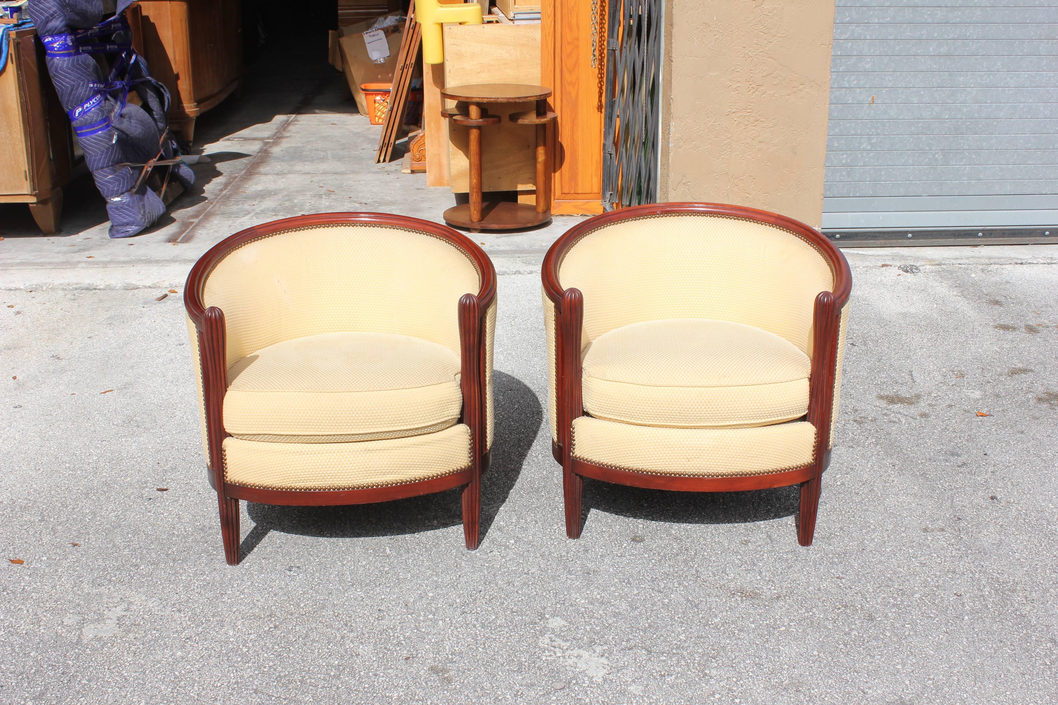 Monumental pair of French Art Deco club chairs solid mahogany chair frames are in excellent condition, Attributed by Paul Follot, circa 1940s. The curve of the club chair are beautiful .We traveled to buy all our pieces in France .We bought this