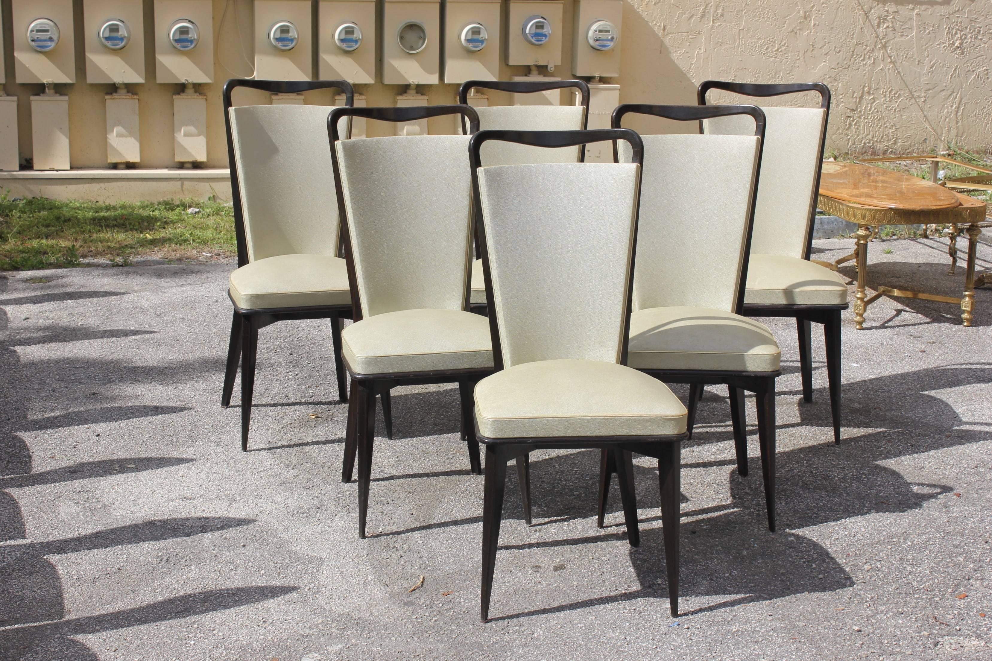 A set of six French Art Deco solid Macassar ebony dining chairs, circa 1940. Chair frames are in excellent condition .The vinyl are in good condition champagne color (reupholstery is vinyl recommendedfor all 6 dining chairs). Size 18.50" W ×