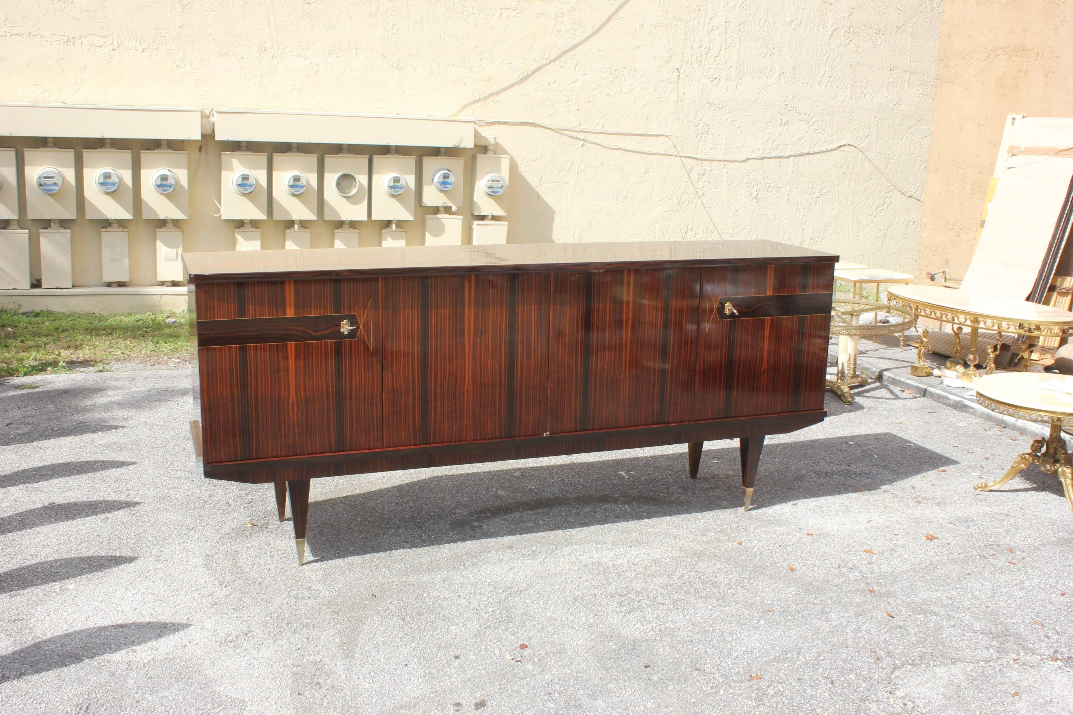 French Art Deco exotic Macassar ebony sideboard or buffet the piece have four doors with beautiful inlay in perfect condition, circa 1940s. Please note these buffets can be taken apart to accommodate elevator needs if necessary. We traveled to buy