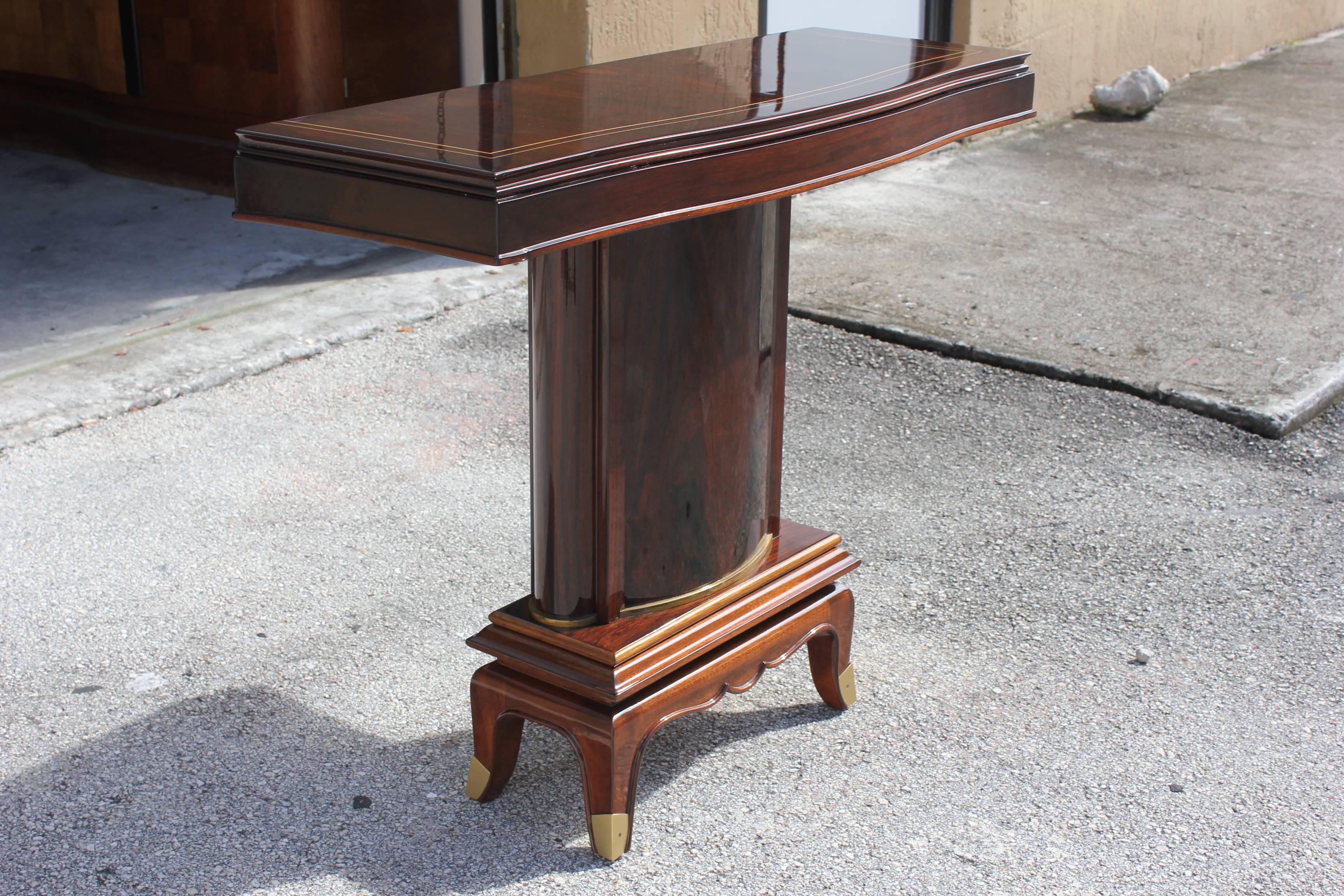 A stunning pair of French Art Deco palisander console tables by Jules Leleu, circa 1930s. Beautiful inlay and bronze banding around base. Exquisitely crafts. Refinished with a high gloss finish.