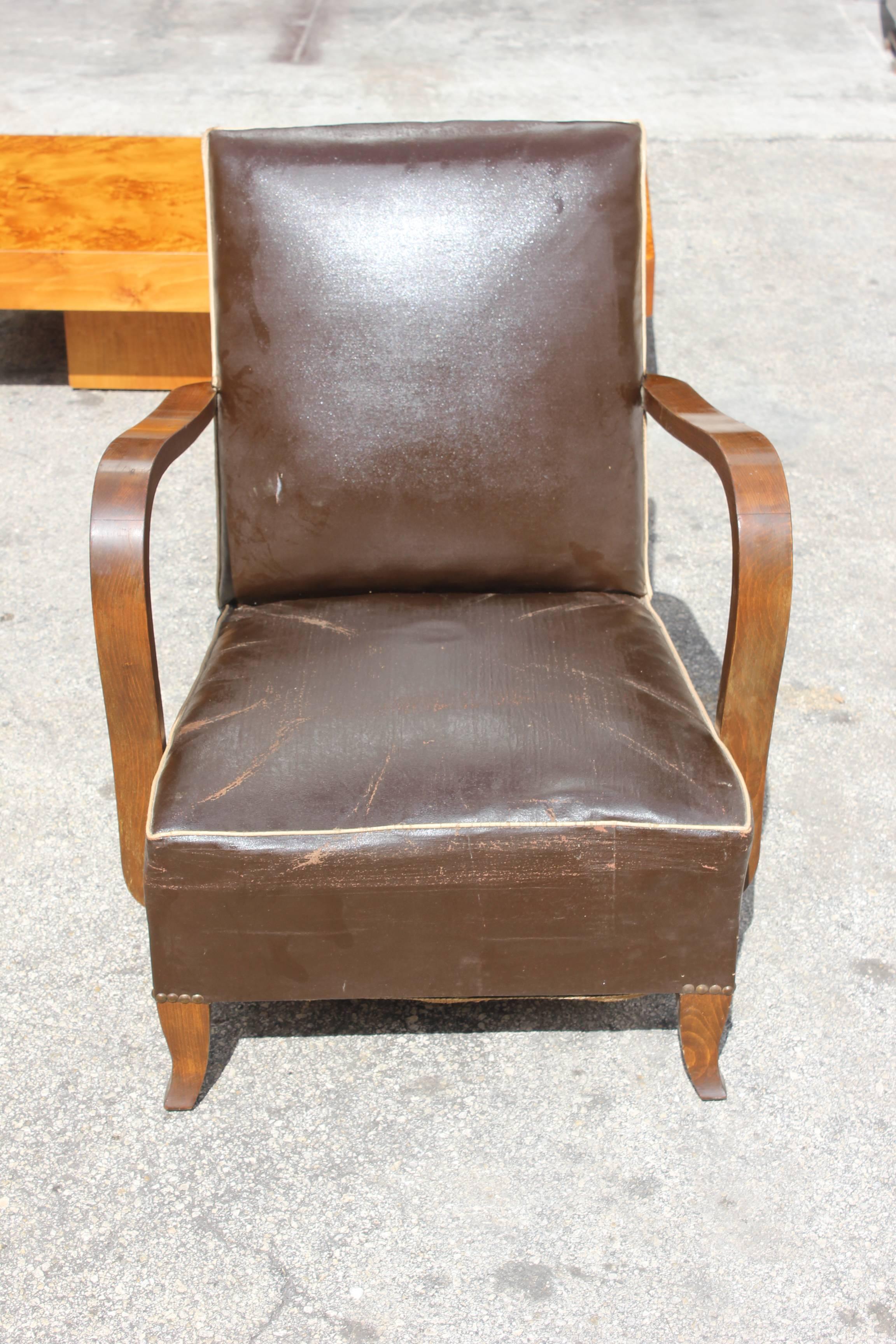 A pair of French Art Deco walnut club chairs. Reupholstery recommended.