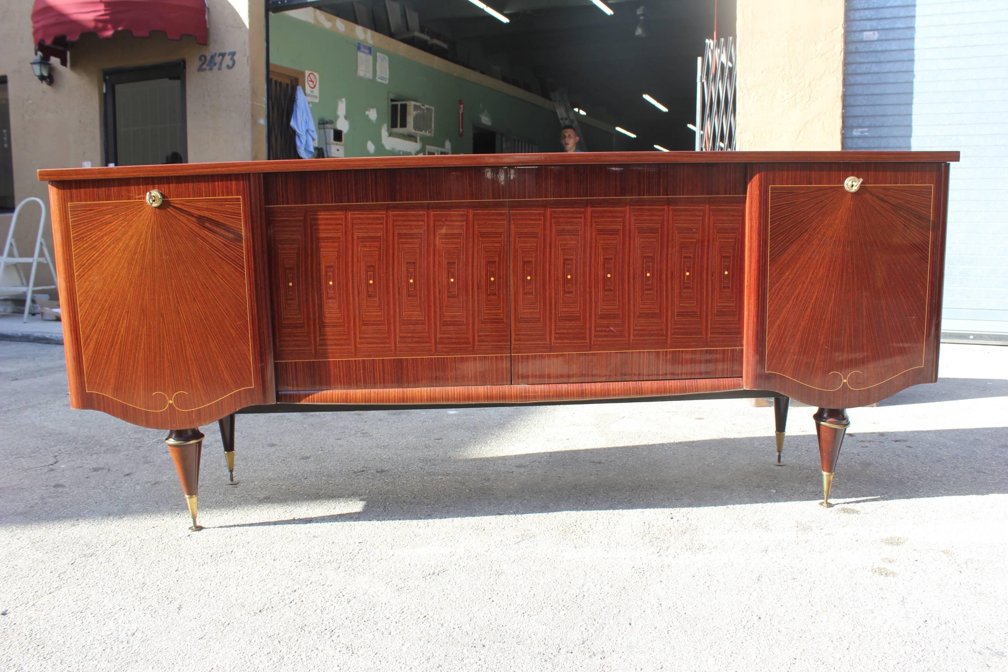 A French Art Deco/Art Moderne sideboard / buffet Macassar ebony sunray with mother-of-pearl inlay, circa 1940s .High gloss finish.