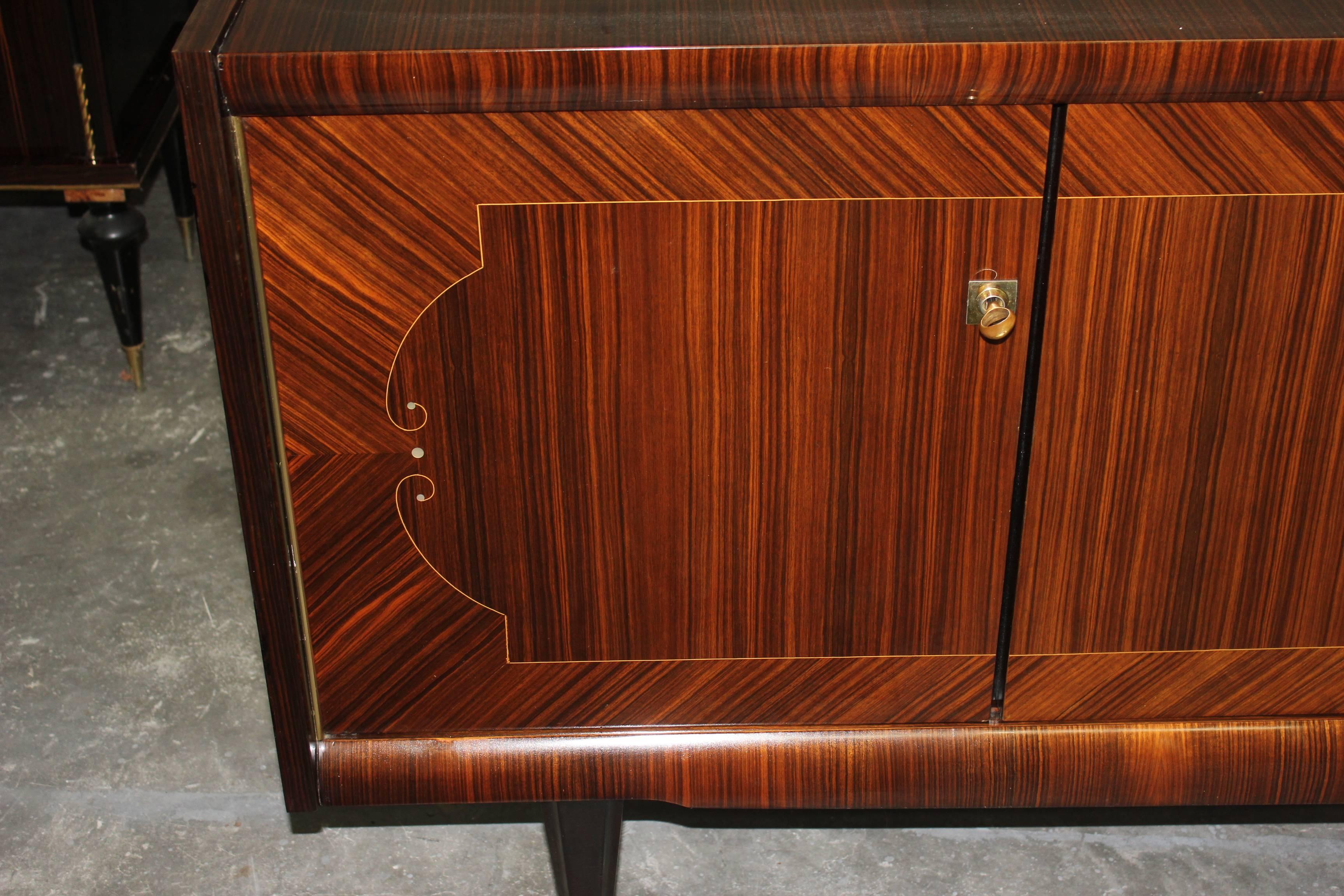 A French Art Deco Sideboard / Buffet Macassar ebony with M-O-P detail ,circa 1940s. High gloss finish and Finished interior.