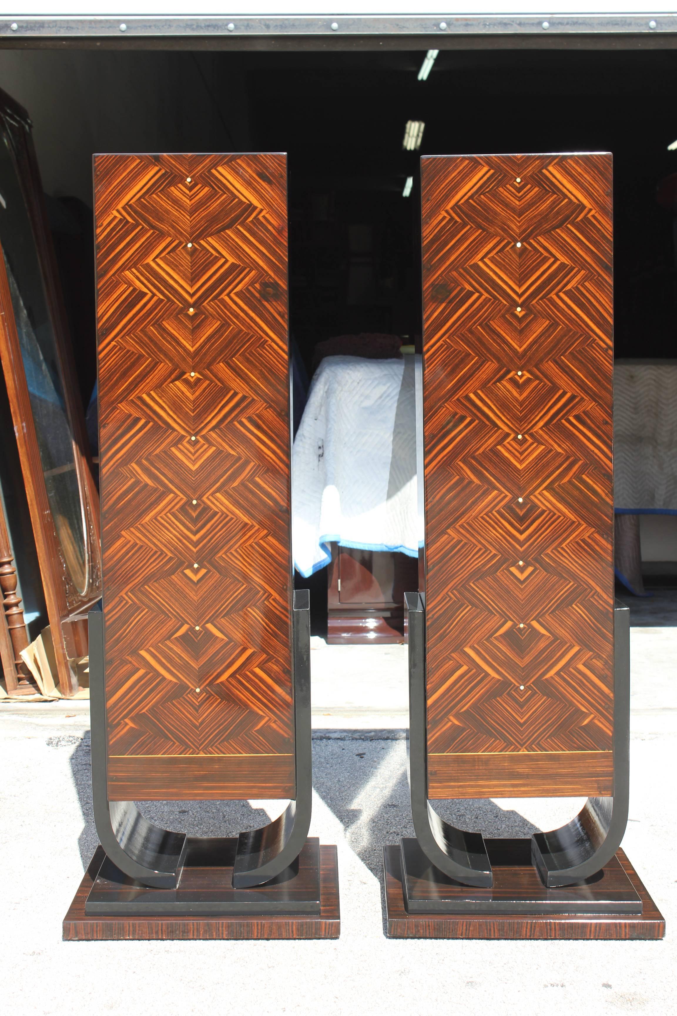 A pair of very grand French Art Deco Exotic Macassar Ebony Pedestals, circa 1940s. Parisian estate items, we are currently liquidating the contents of. These pedestals are finished on all sides. Tulip base, mother of pearl accents in the center.