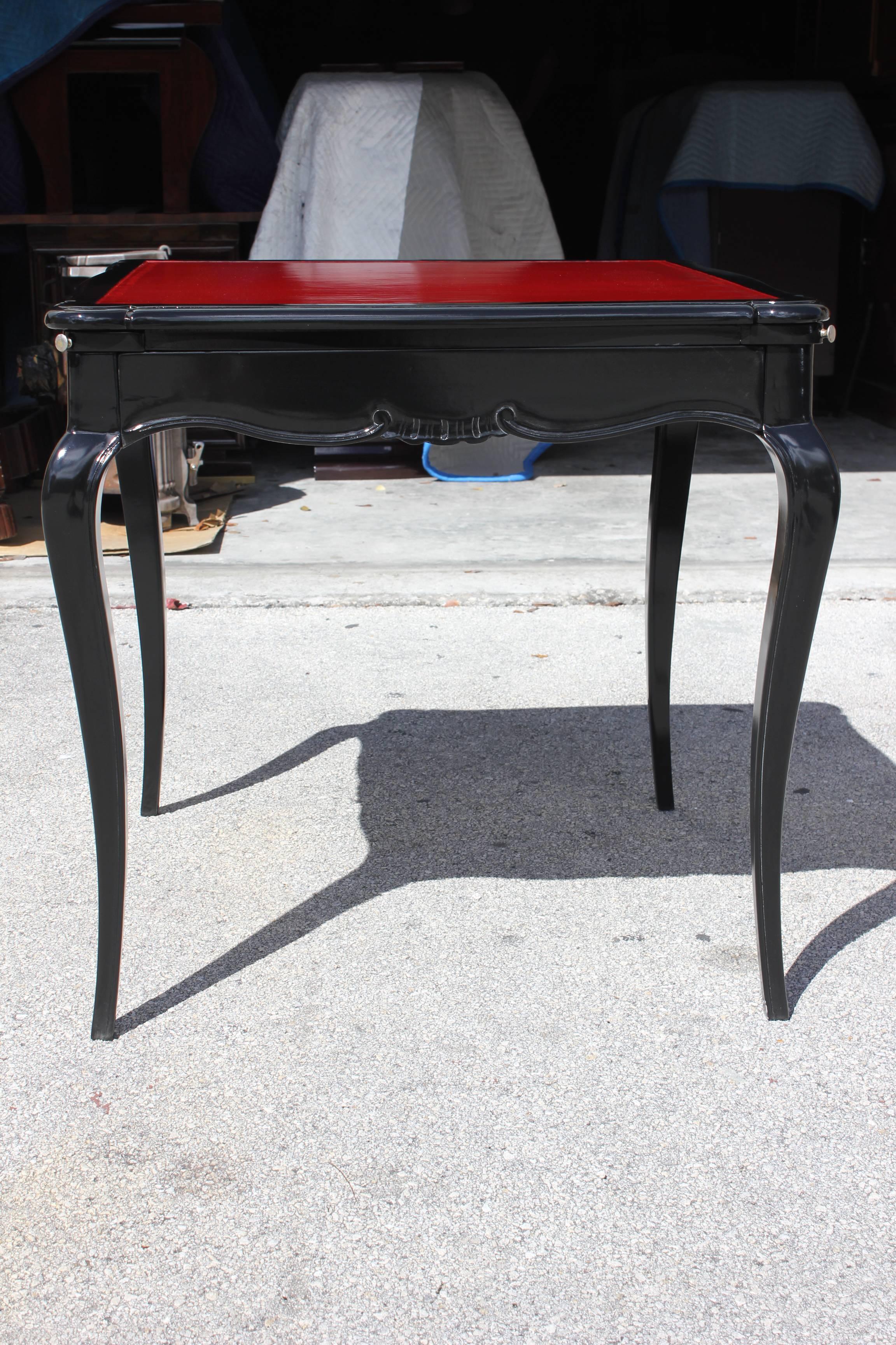 A spectacular French Art Deco Black Lacquered with Red Top Gaming Table, style Jules Leleu, circa 1940s. Pull out drink holders. Stunning detail. Pull out drawer.