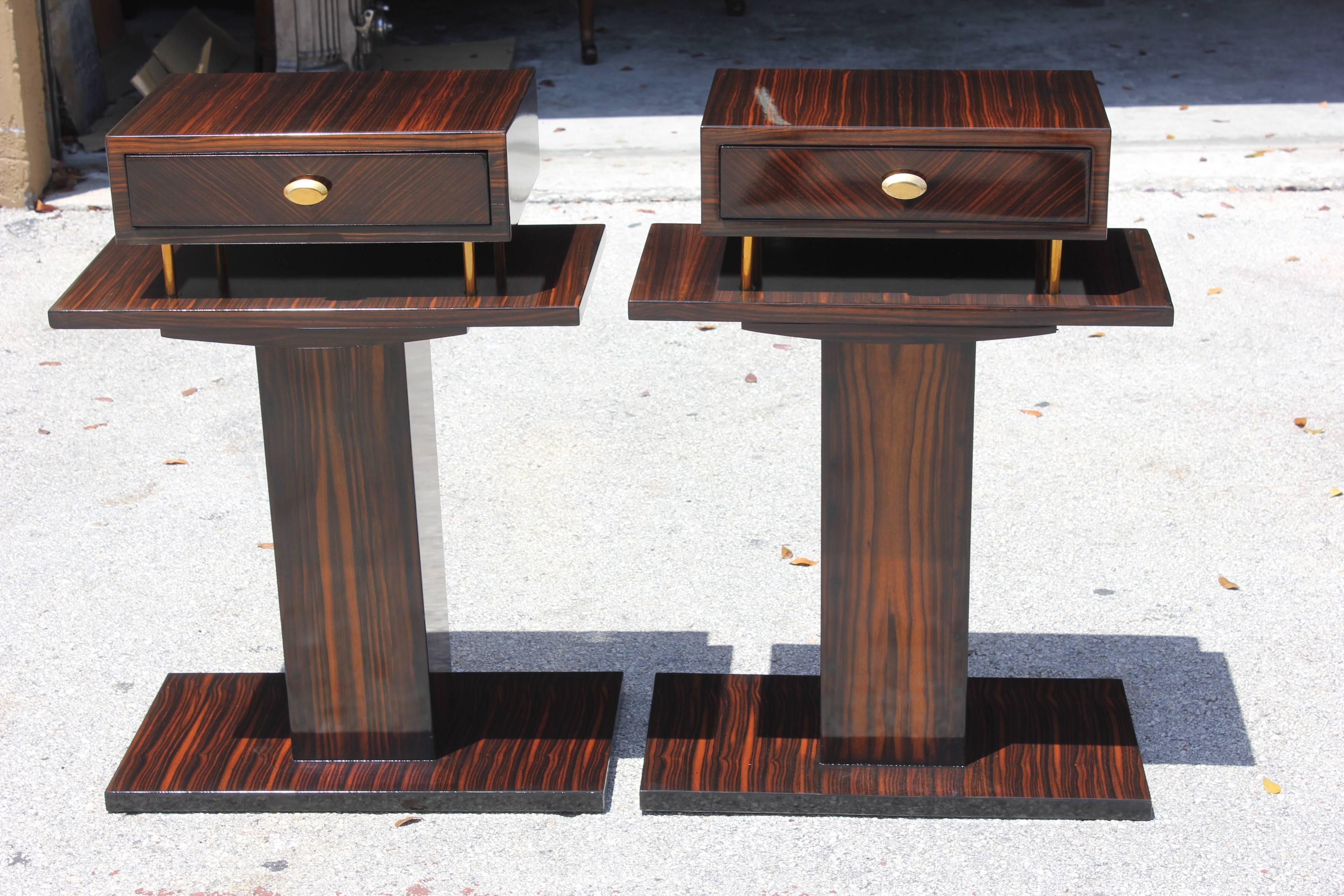 A pair of stunning French Art Deco exotic Macassar ebony end tables or night stands. Center Macassar column with Macassar shelf and drawer. French estate items.