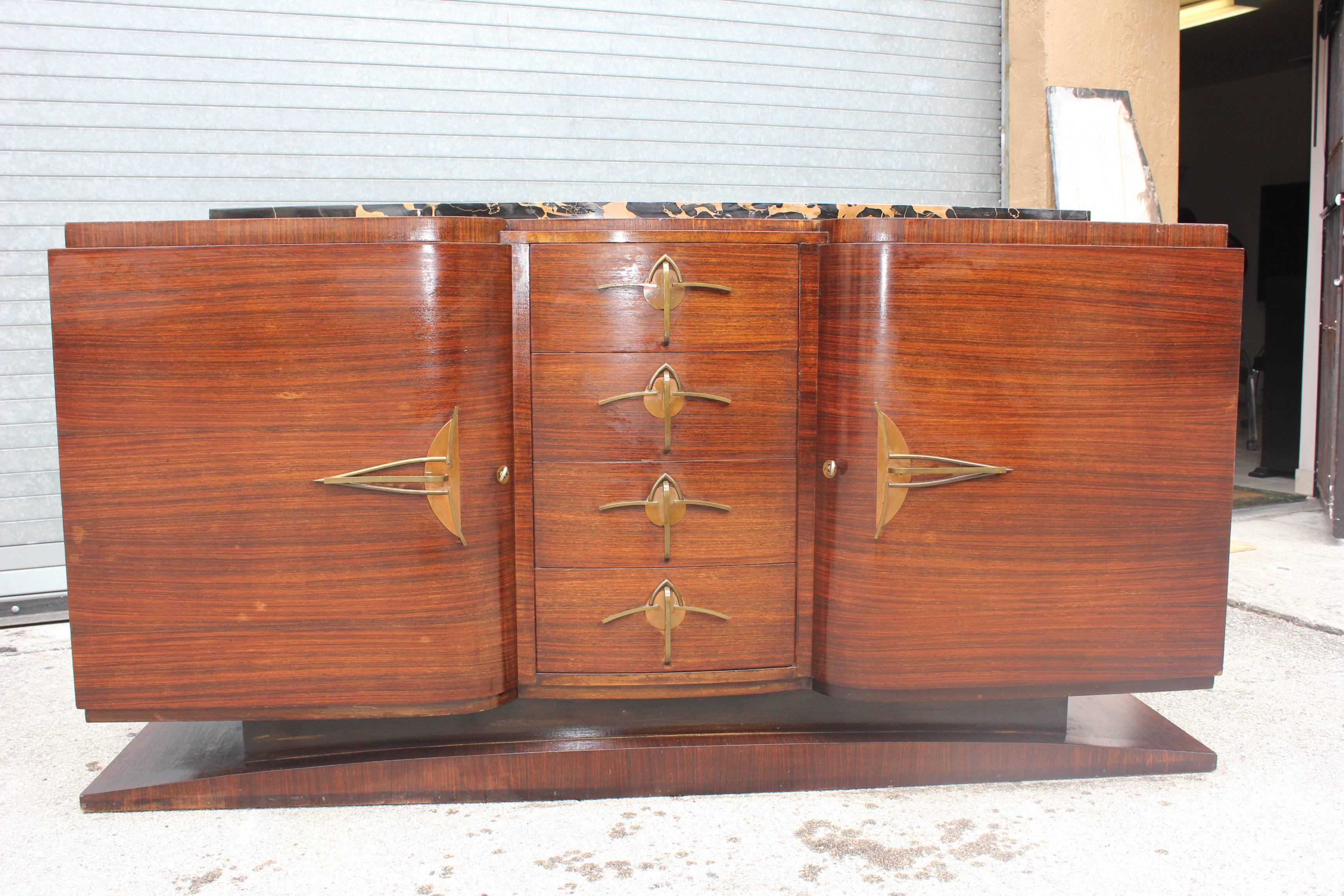 A Classic French Art Deco   Exotic Macassar Ebony sideboard / buffet with black Porto marble top, circa 1940s. The most elaborate deco hardware.(with the original finish in very good condition. )