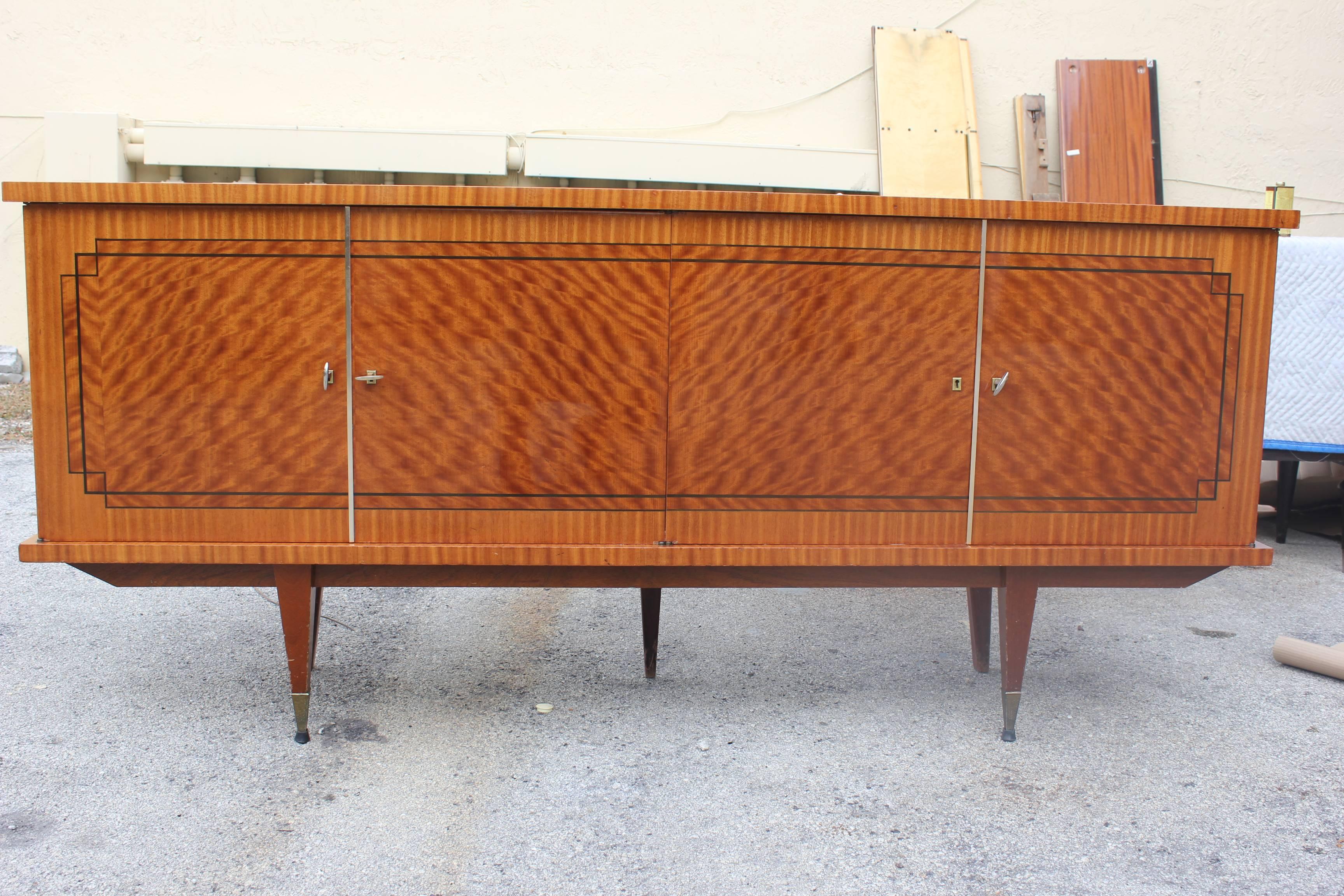 A French Art Deco flame mahogany buffet, circa 1940s. Finished interior. Stunning detail and inlay.