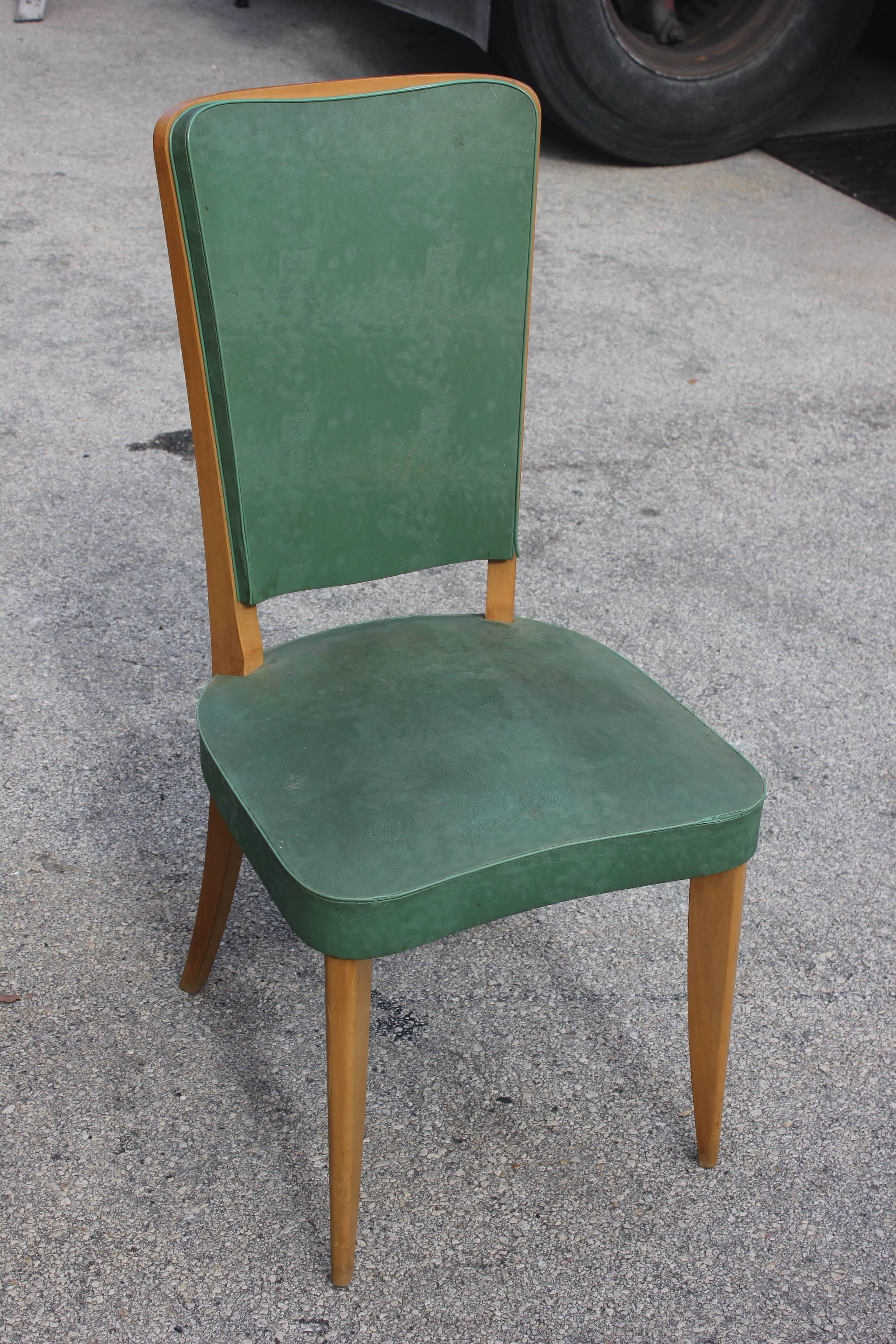 A set of six French Art Deco light walnut dining chairs, circa 1940s. Reupholstery recommended.