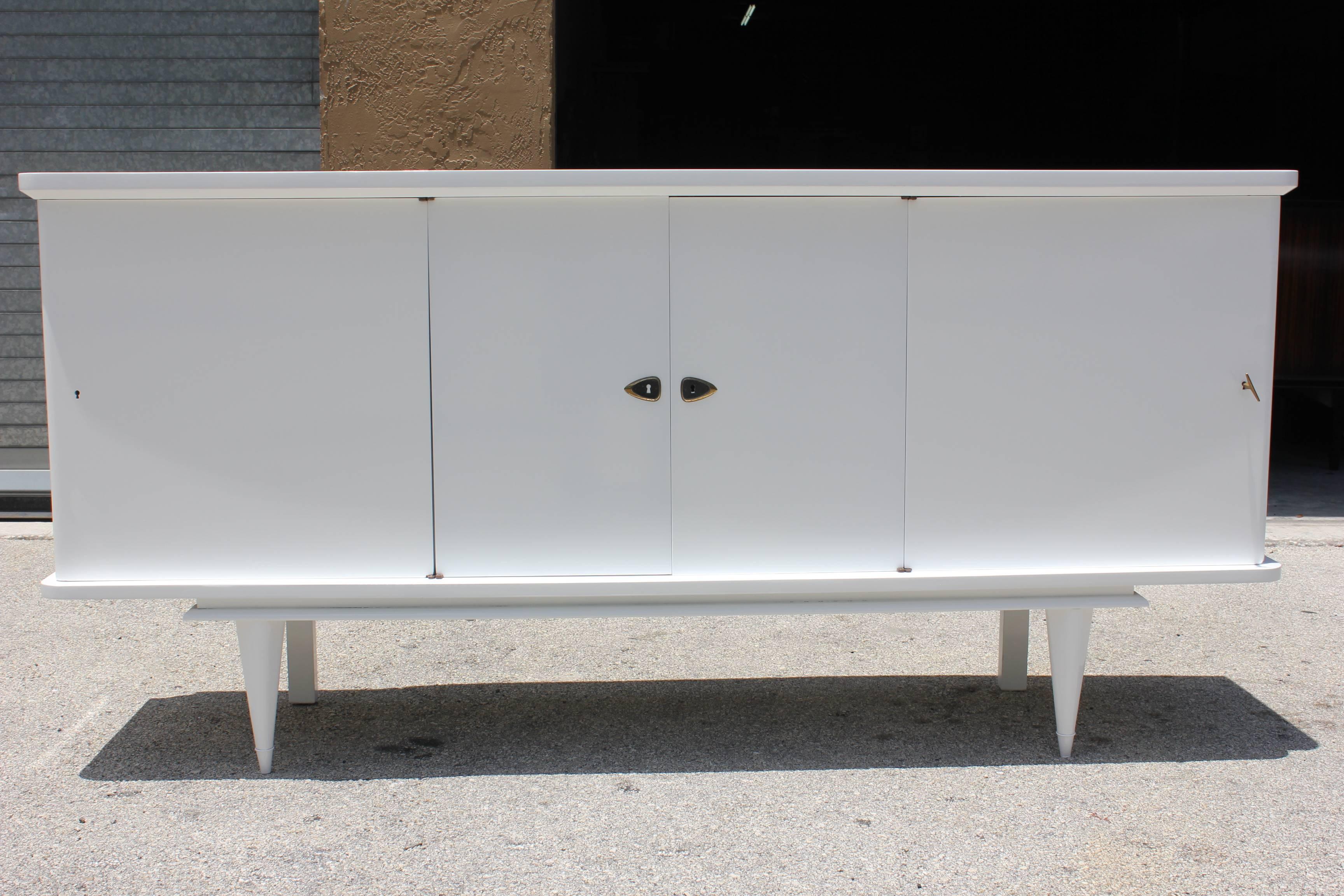 A French Art moderne/ Mid-Century Moderne snow white lacquered sideboard, circa 1950s. Newly lacquered and snow white.