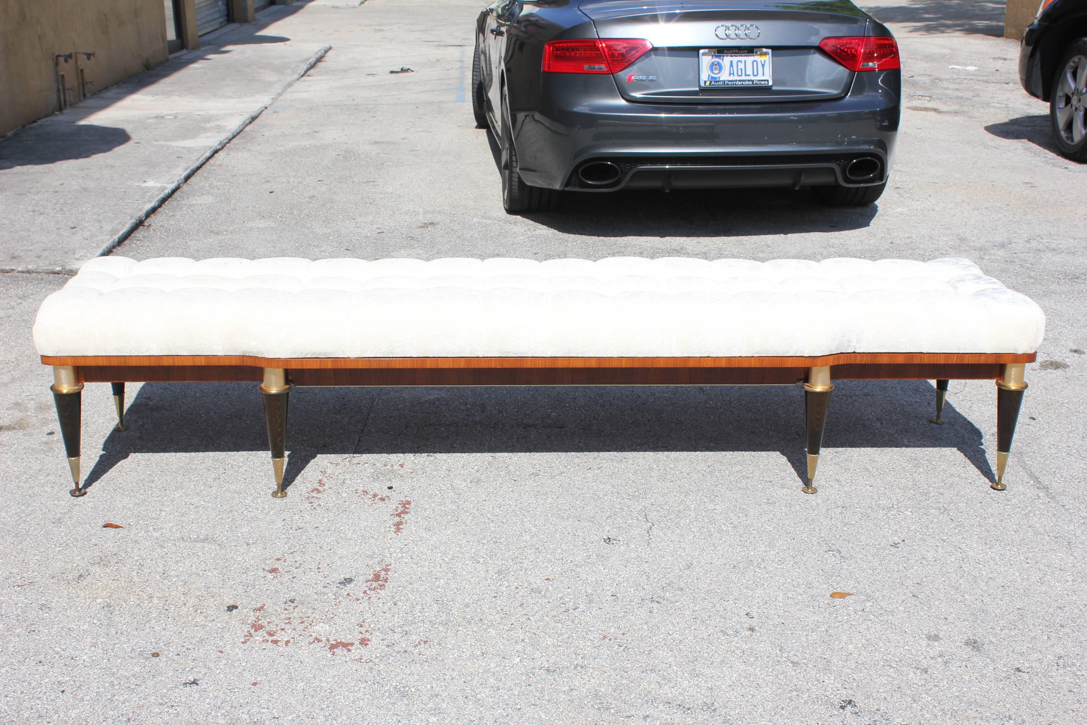 A French Art Deco exotic walnut long sitting bench, circa 1940s. Beautiful detail, stunning legs. Newly upholstered.