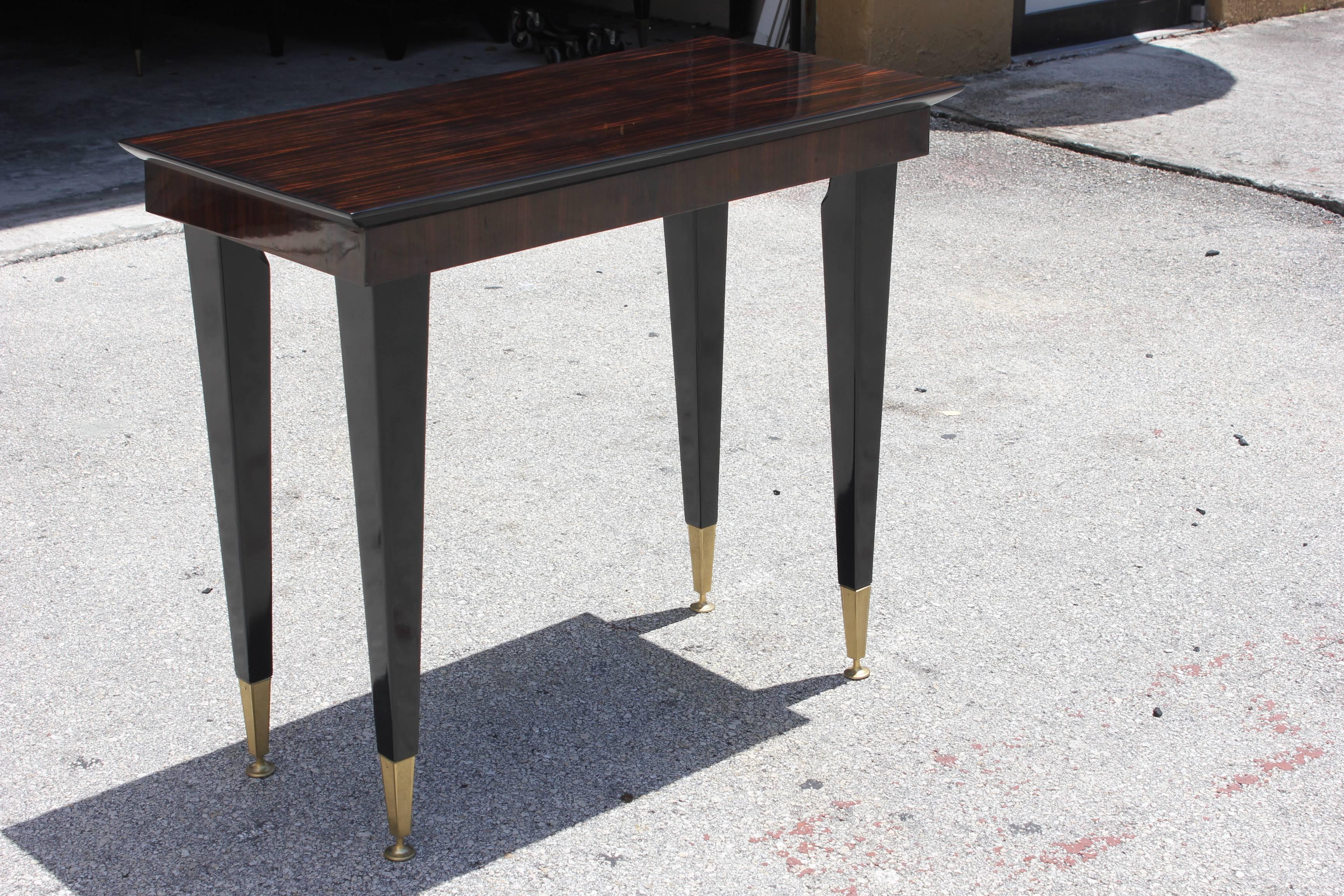 A French Art Deco exotic Macassar ebony console table, circa 1940s. Black lacquer legs and toe caps. Stunning piece!