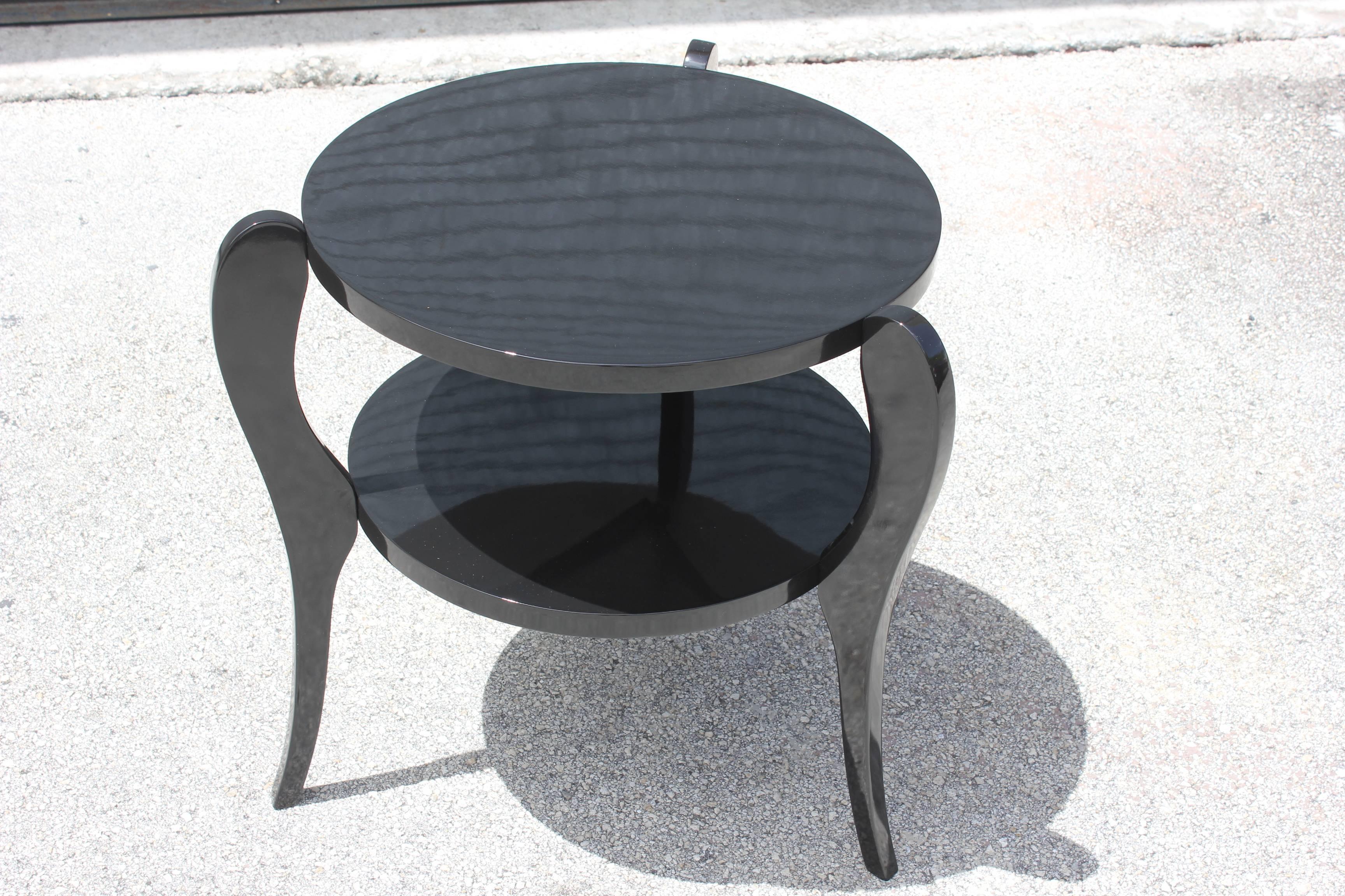 A French Art Deco tri-leg two-tier black lacquer accent table, circa 1940s. Newly refinished and lacquered.