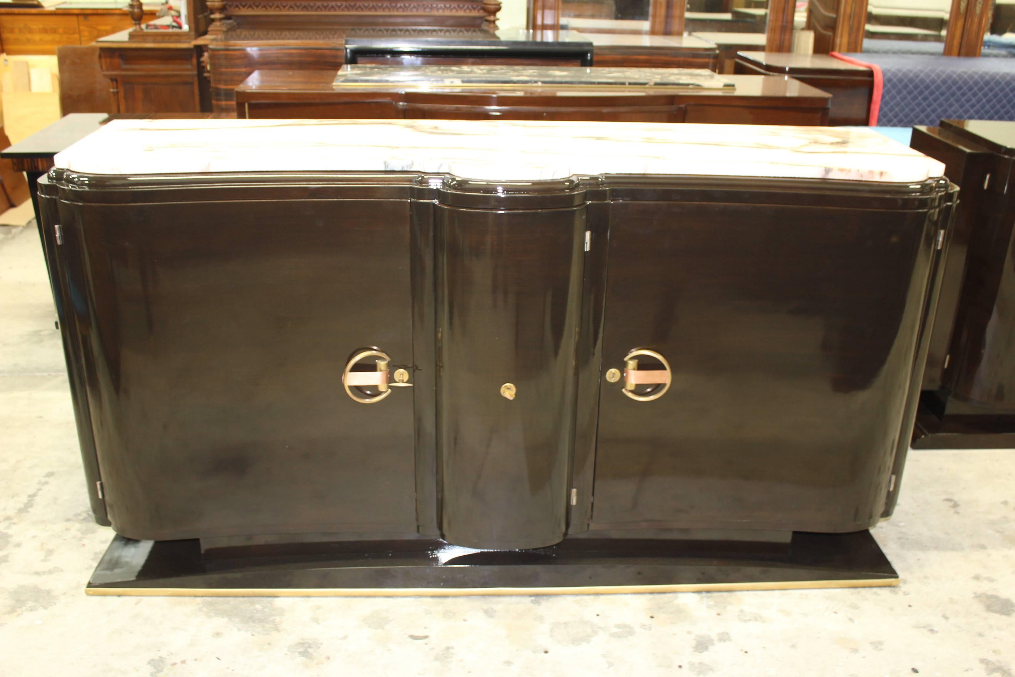 A French Art Deco dark walnut high gloss dry bar/ buffet, circa 1940s. Stunning marble top. Curved center door, elaborate hardware. Newly refinished and lacquered. Glass shelves in the left and right side of cabinet. Another French Art Deco
