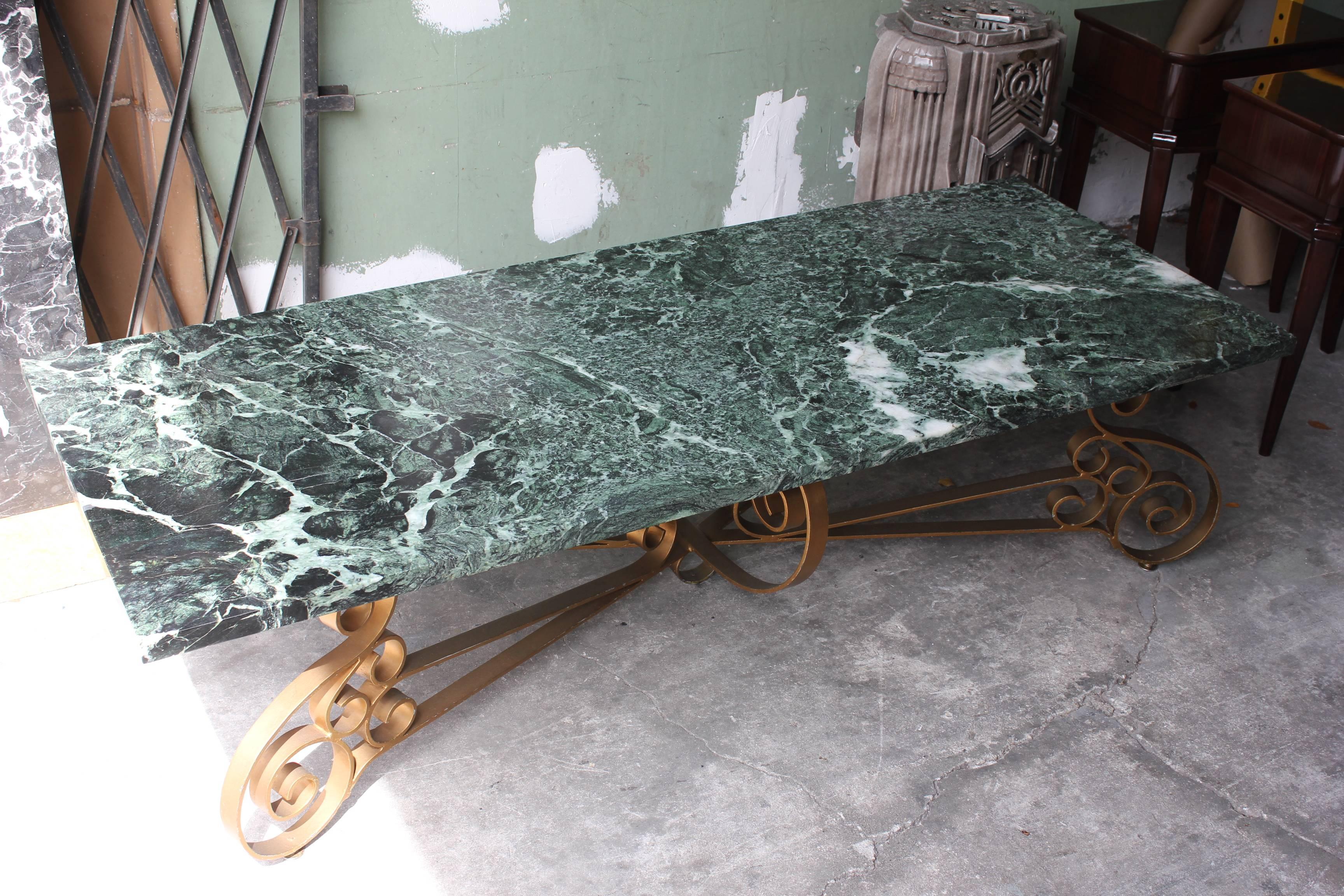 A beautiful Italian Mid-Century Modern scrolled gilt metal and thick Verde marble-top coffee table.