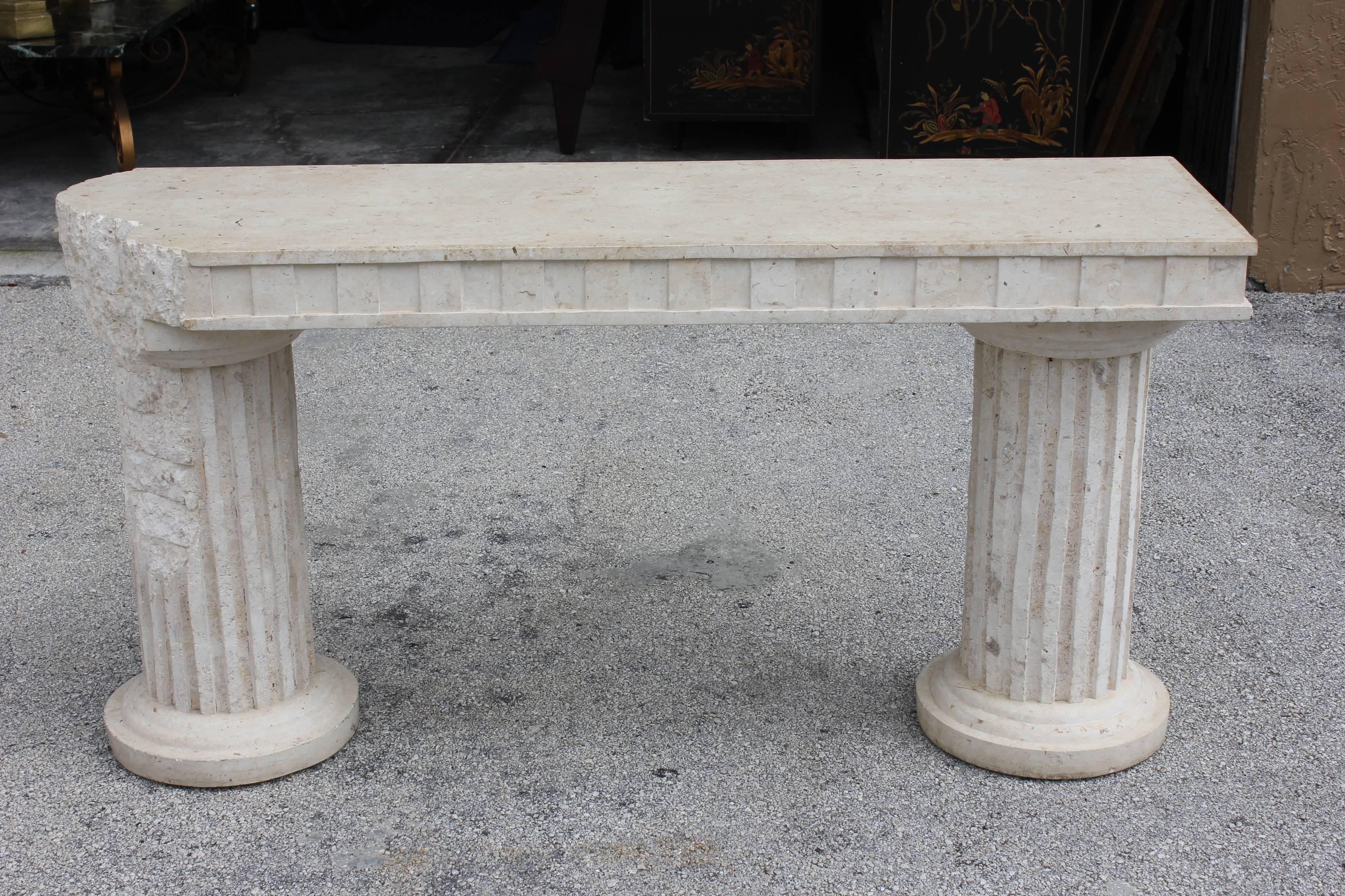 An Italian Mid-Century Modern two-column faux stone console table, circa 1950s.