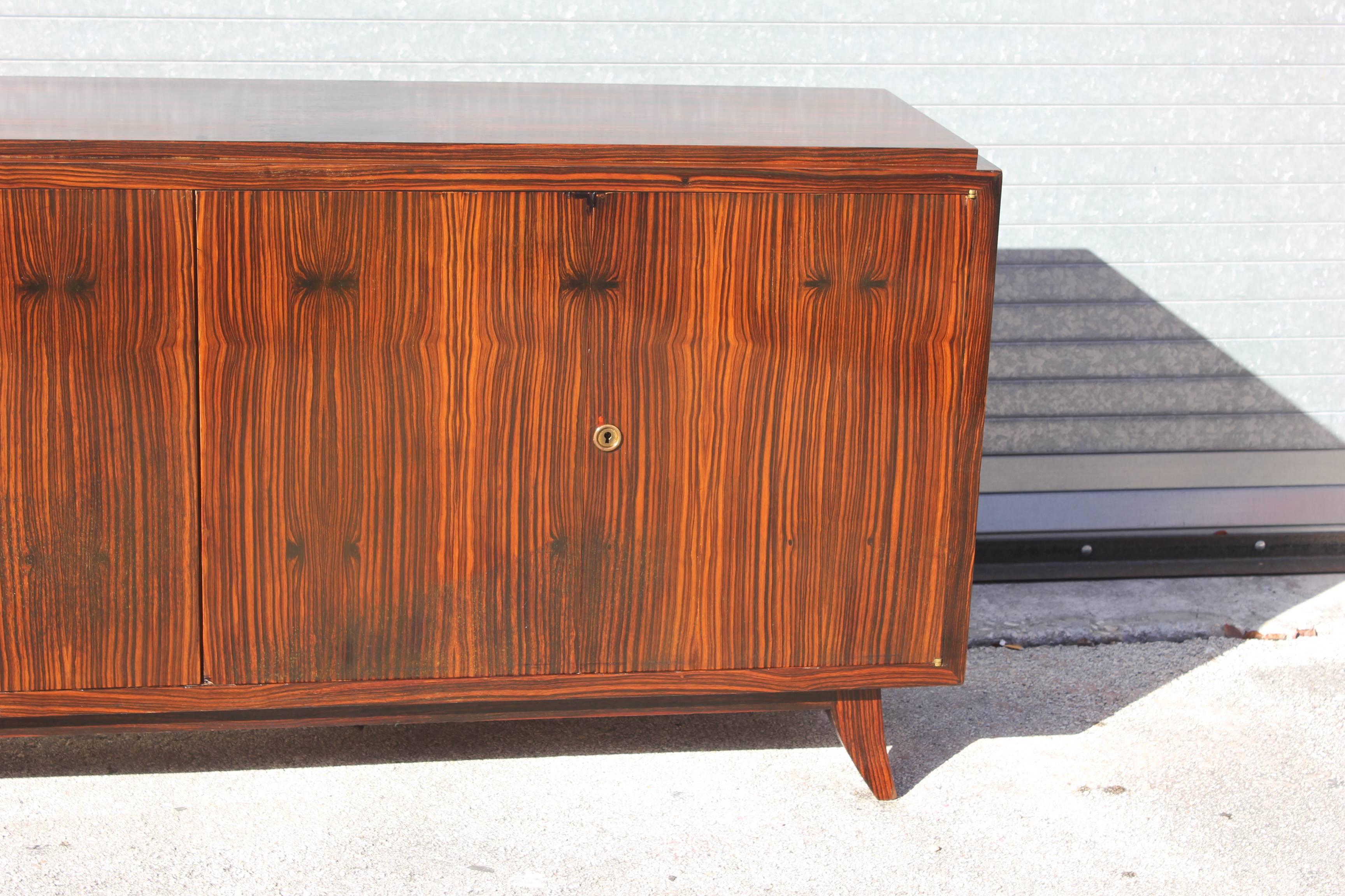 Absolutely stunning French Art Deco Macassar ebony sideboard or Buffet, four doors, most certainly an unsigned designer piece, this sideboard is of the highest quality, circa 1940s.