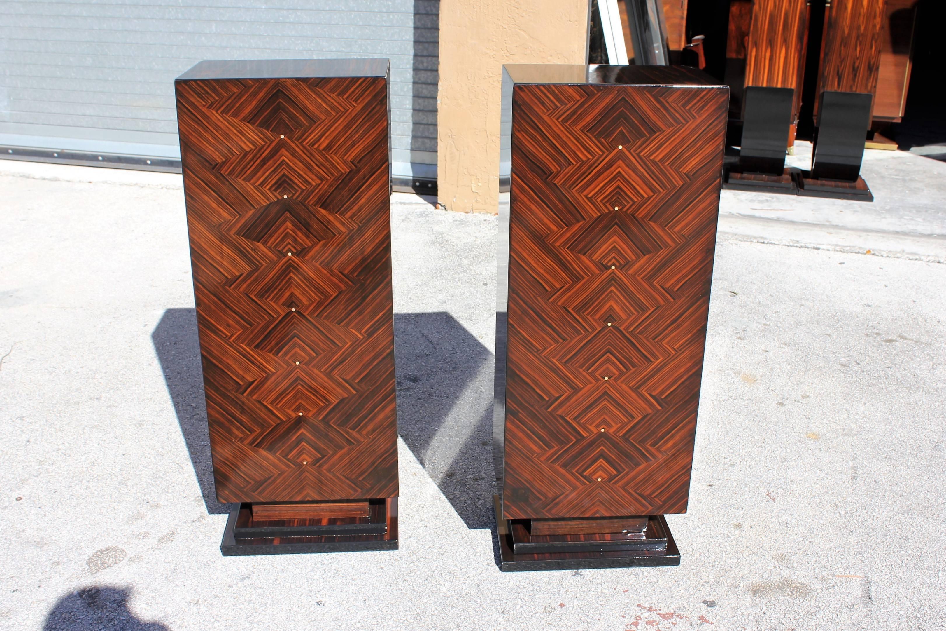 Stunning pair of French Art Deco exotic Macassar ebony pedestals, circa 1940s, we are currently liquidating the contents of. These pedestals are finished on all sides. Square base, mother-of-pearl accents in the center. These pedestals are stunning.