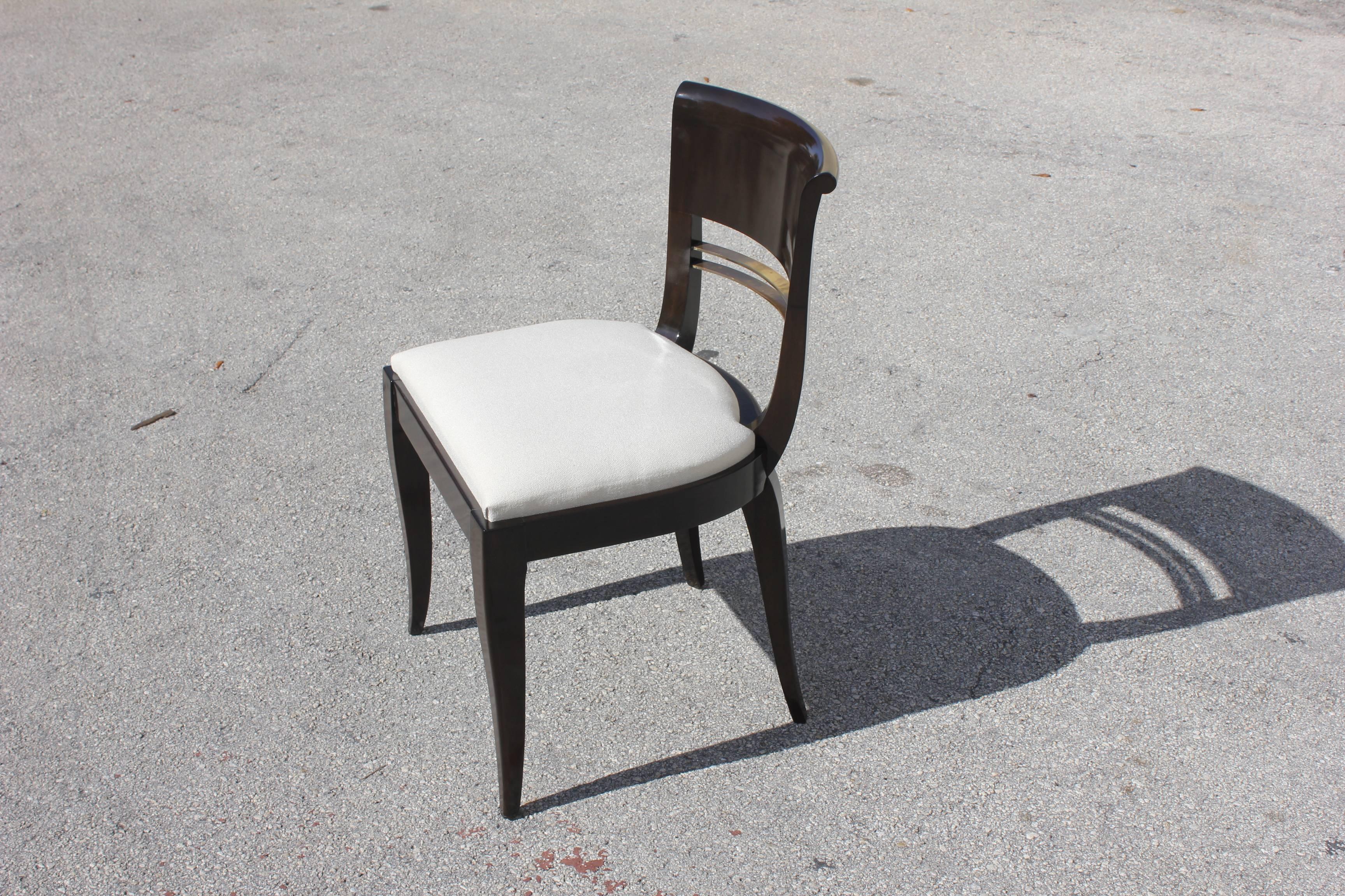 Suite of four Art Deco dining chairs Macassar ebony by Maurice Rinck, circa 1930. Very high quality chairs. High gloss finish with bronze design in the back.