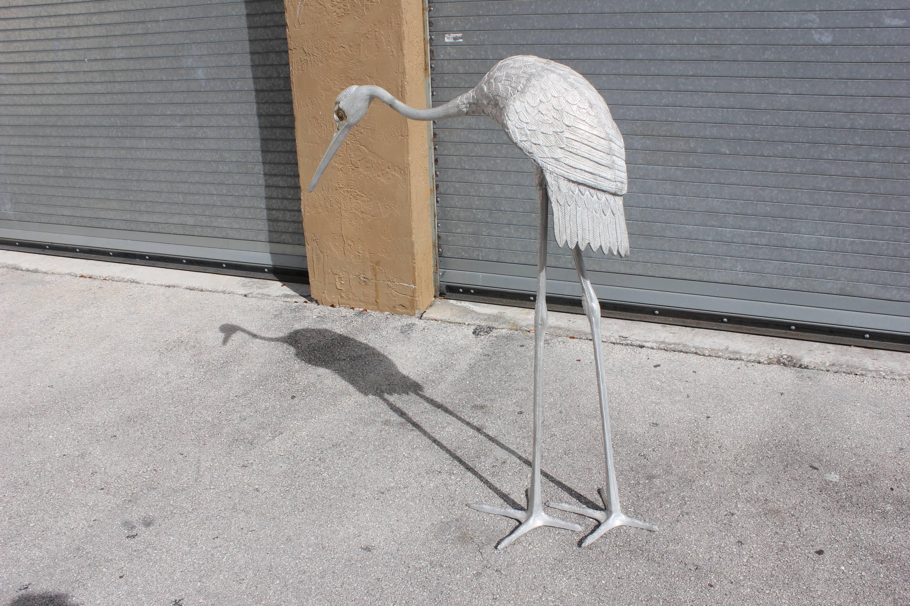Beautiful white metal Art Deco sculptures flamingos, circa 1950 .The sculptures are finished in original color. The piece has a fantastic presence and they display very well indoors or outdoors. The pieces are very large in size standing at 52 high