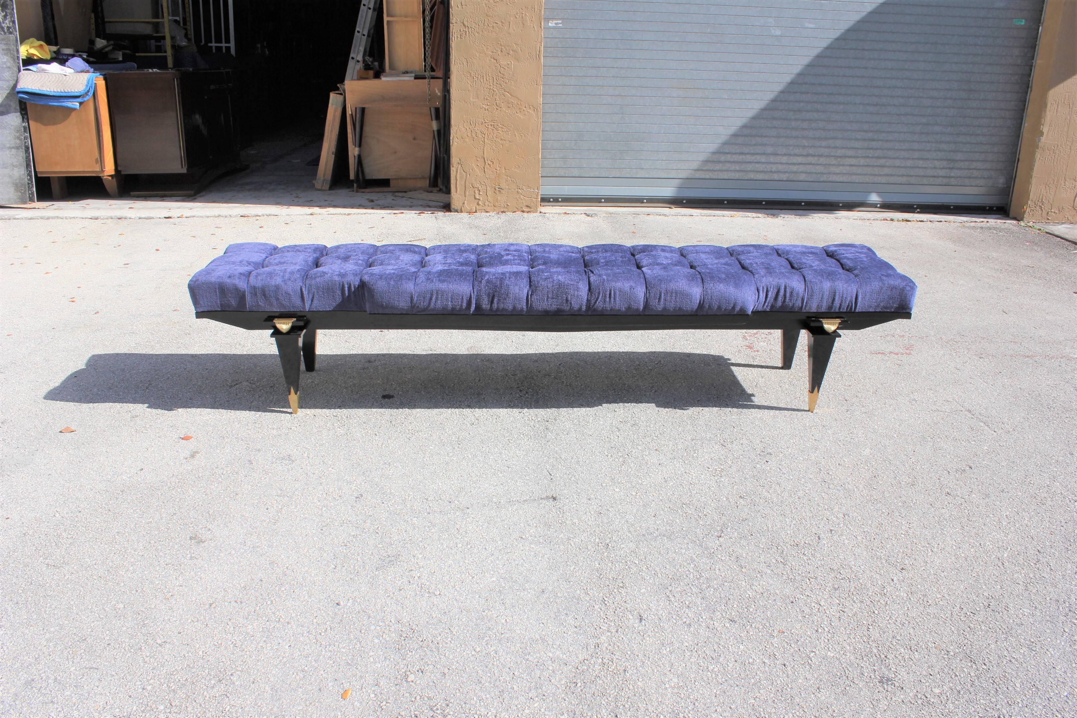 A stunning French Art Deco exotic Macassar ebony sitting bench, circa 1940s. Newly upholstered in a very high textile royal blue. Gorgeous brass detail. From France.