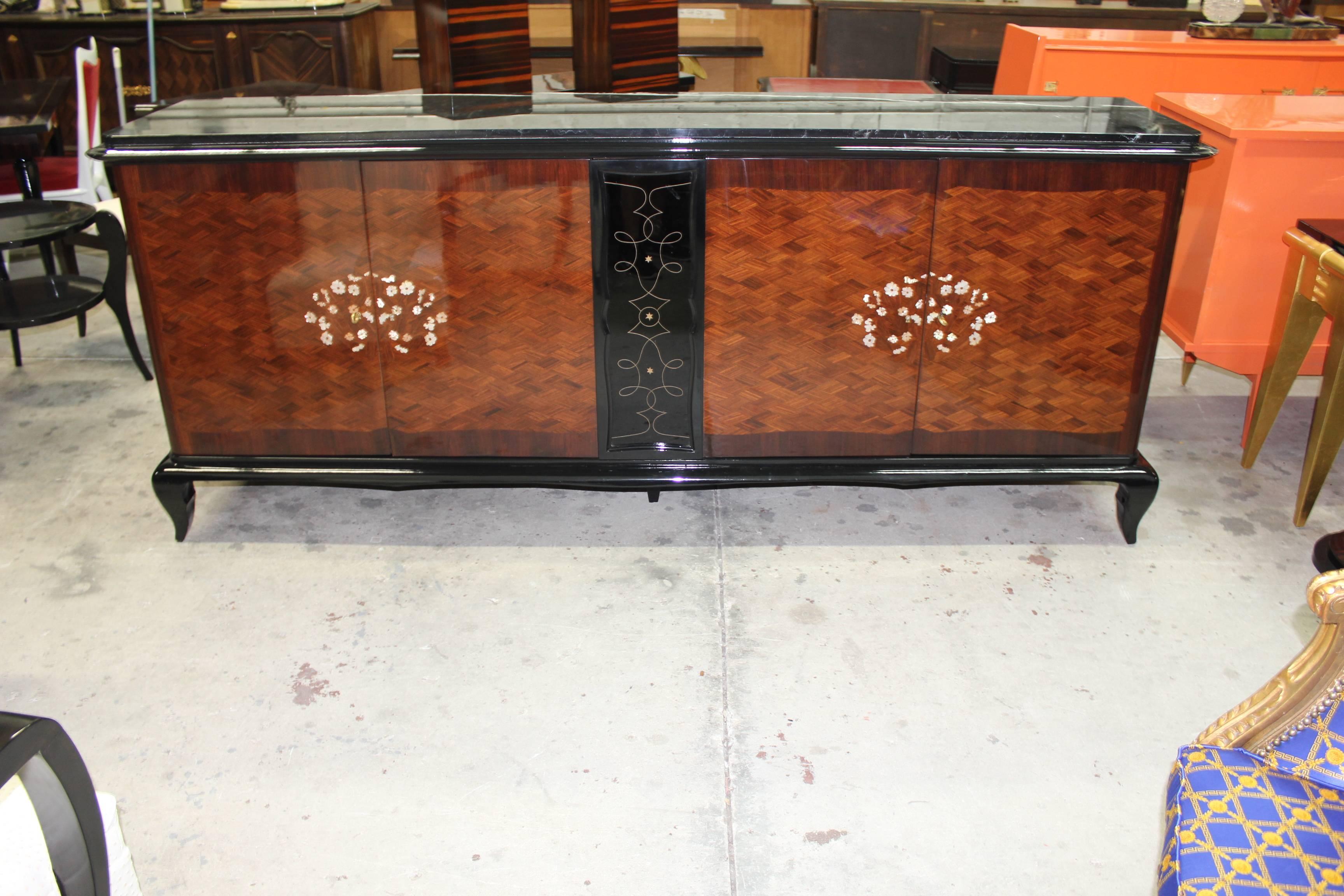 A stunning French Art Deco palisander marquetry with mother-of-pearl and black opaline glass accented sideboards, buffets or bar. Beautiful detail throughout, in the style of the master Jules Leleu. Very fine craftsmanship and finished interior,