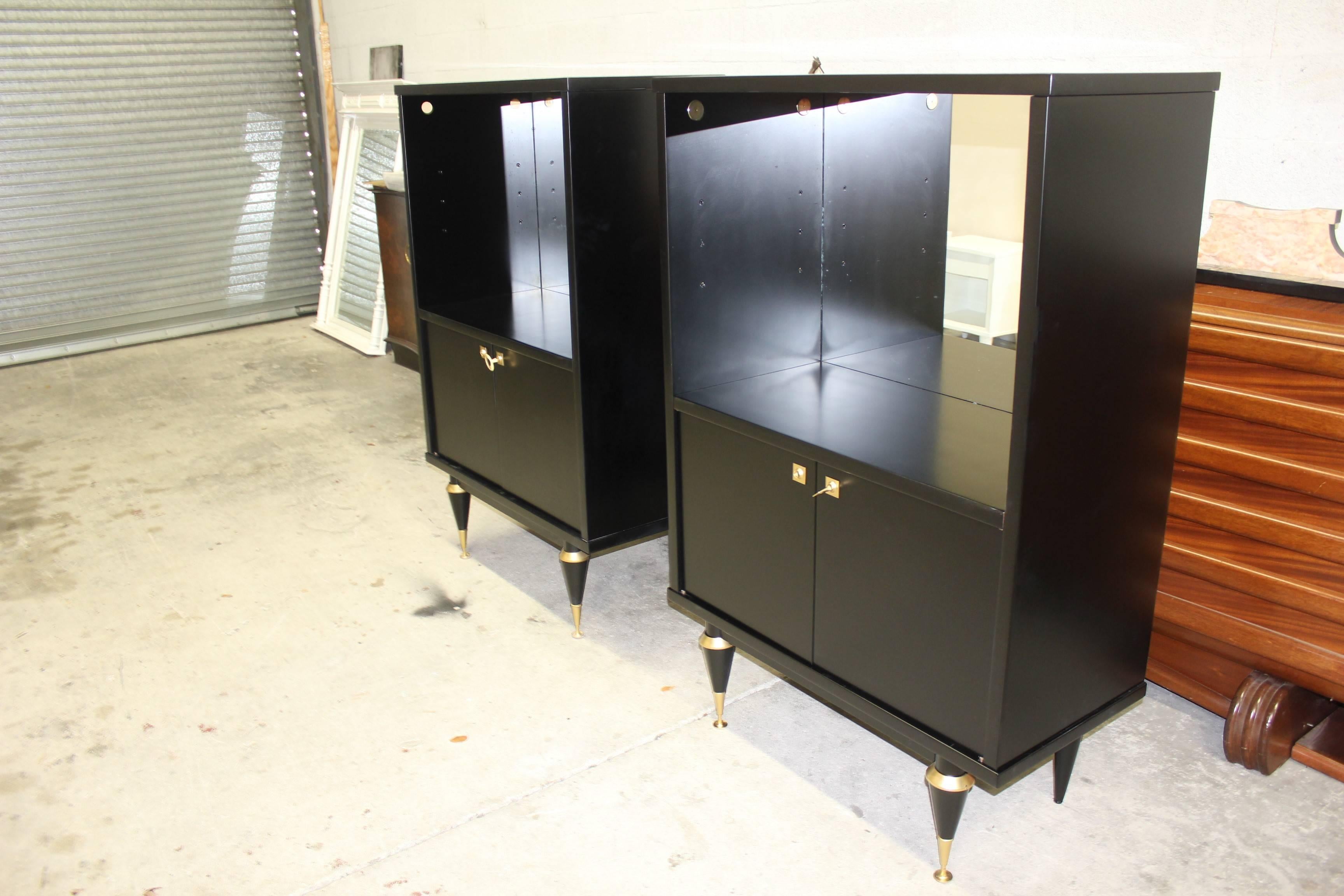 Beautiful pair of French Art Deco tall sideboard or display cabinets with mirror inside ebonized, circa 1940s with display area from France, Paris.