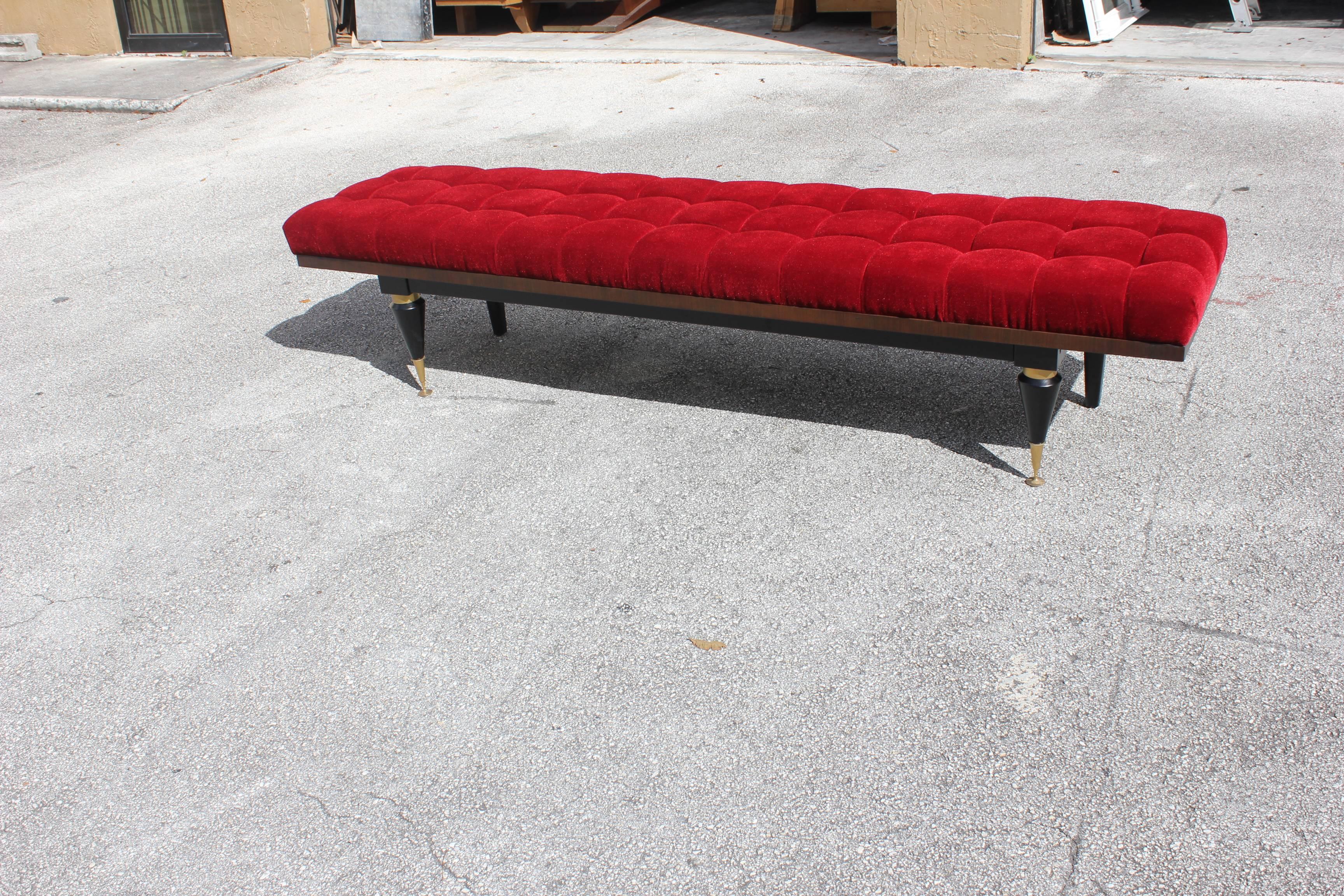 A French Art Deco exotic Macassar ebony red velvet sitting bench, circa 1940s. Newly upholstered in a very high textile velvet red, with brass caps. Size 88.50 W, 21 D, 20 H.