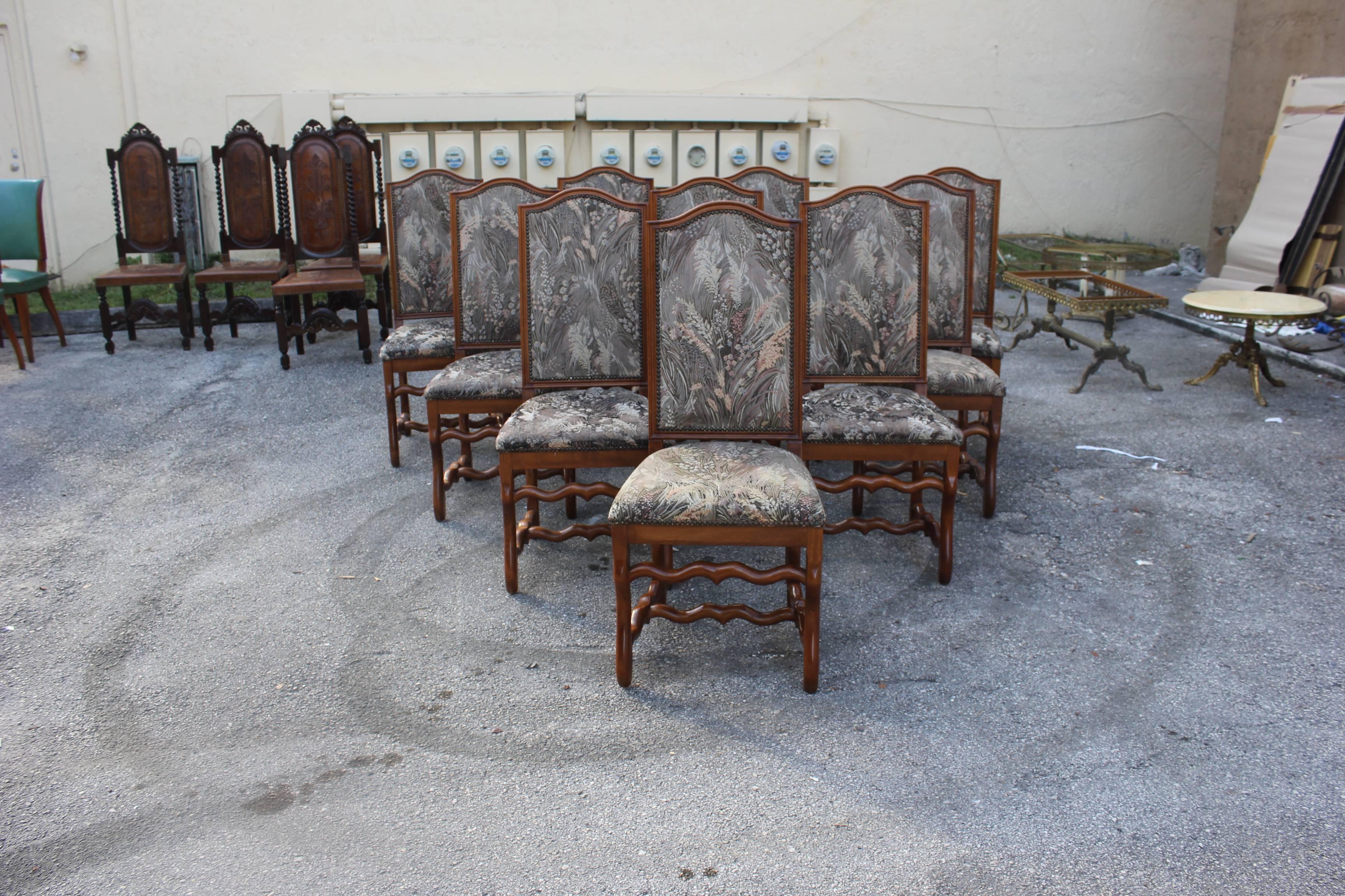 Monumental set of ten Louis XIII style Os de Mouton dining chairs with chapeau de gendarme backs, circa 1880s. Vintage fabric upholstery with nailheads, solid walnut chair frames are in excellent condition. From South France Bordeaux. ( fabric