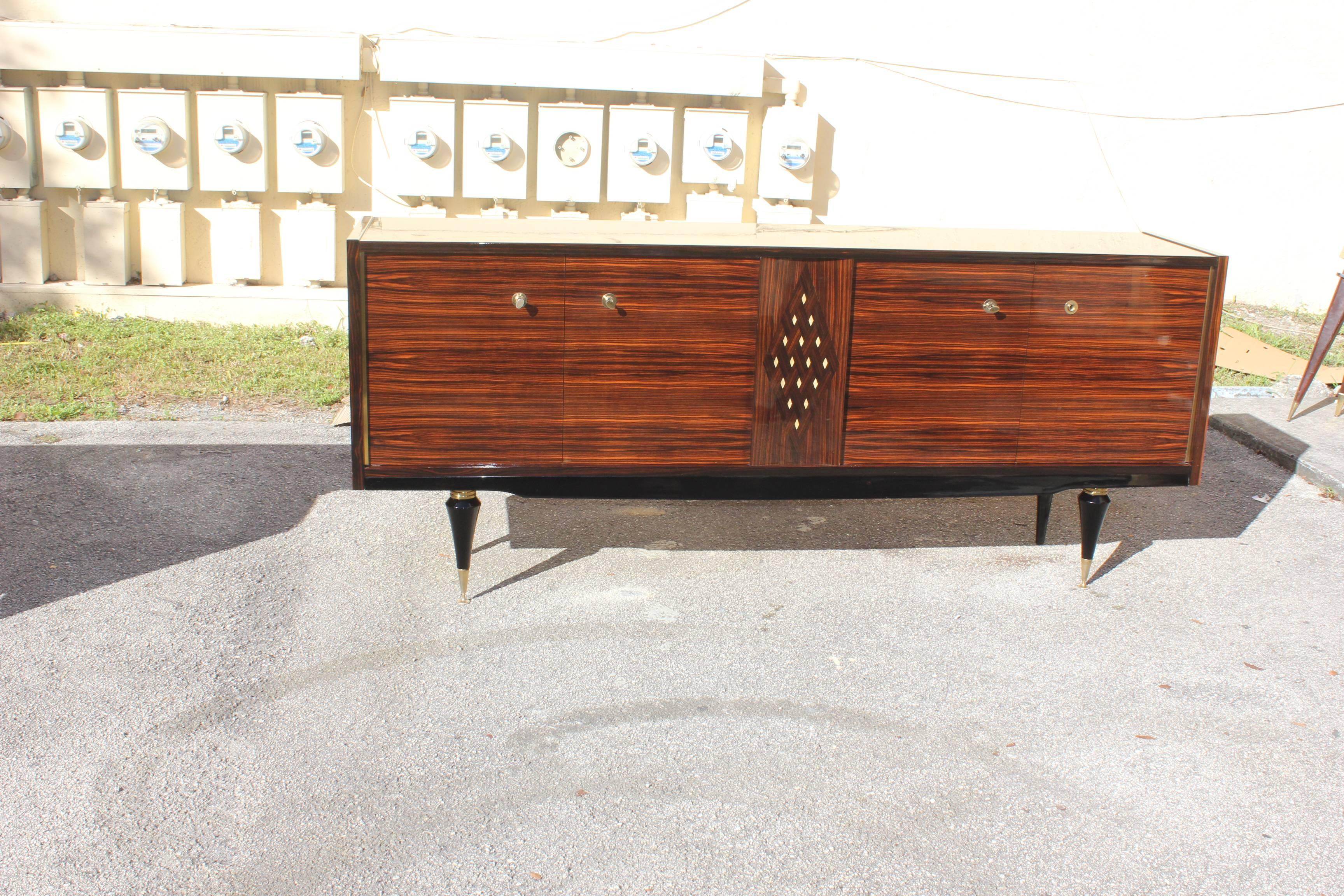 Beautiful French Art Deco Macassar ebony sideboard/buffet with diamond mother-of-pearl center, circa 1940s. Very nice sideboard with diamond Mother-of-Pearl Center with the Macassar ebony wood the sideboard are in very good condition, the piece have