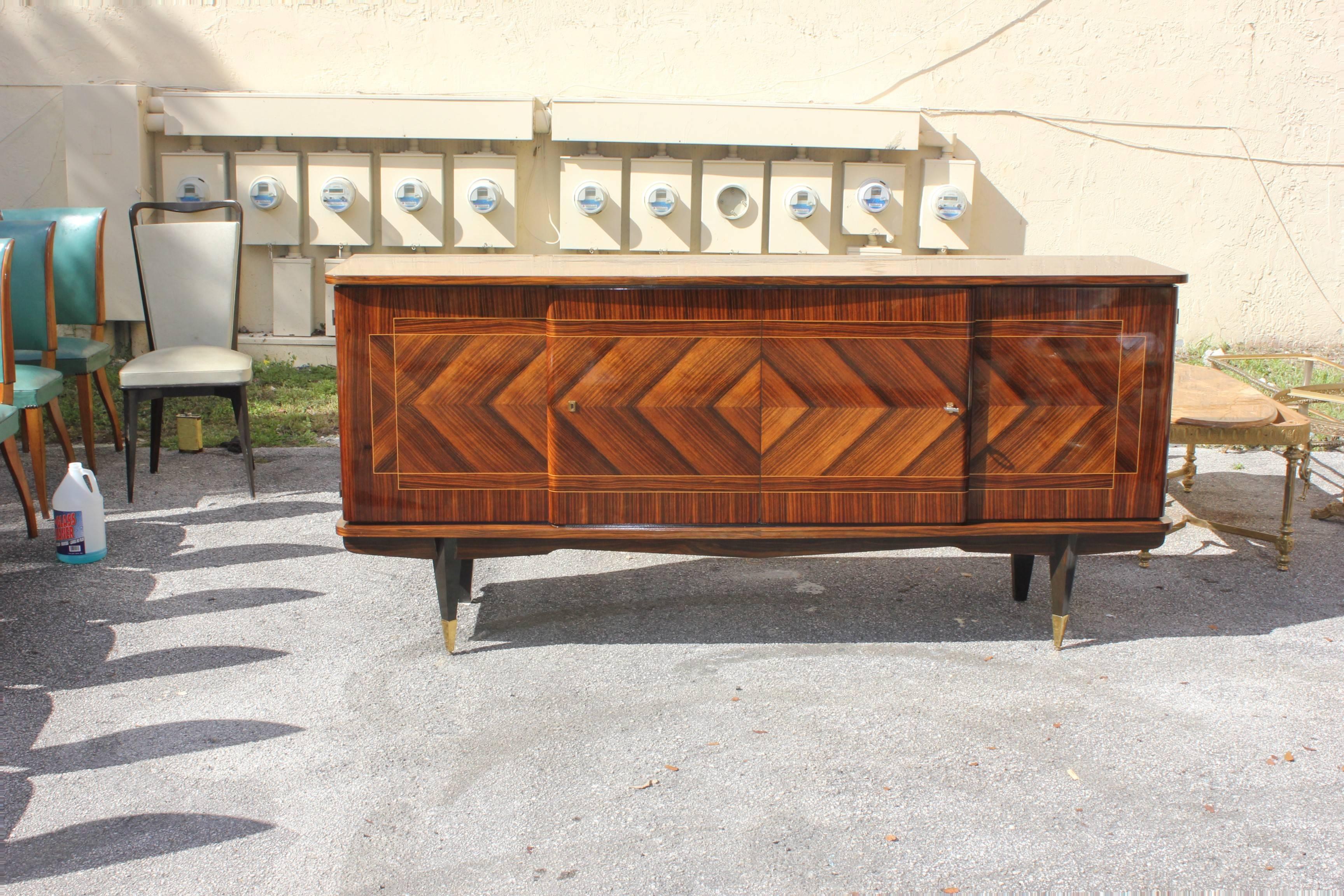 Long French Art Deco zig zag design exotic Macassar ebony sideboard or buffet in perfect condition, circa 1940. The piece has four doors with adjustable shelf. Please note these buffets can be taken apart to accommodate elevator needs if necessary.