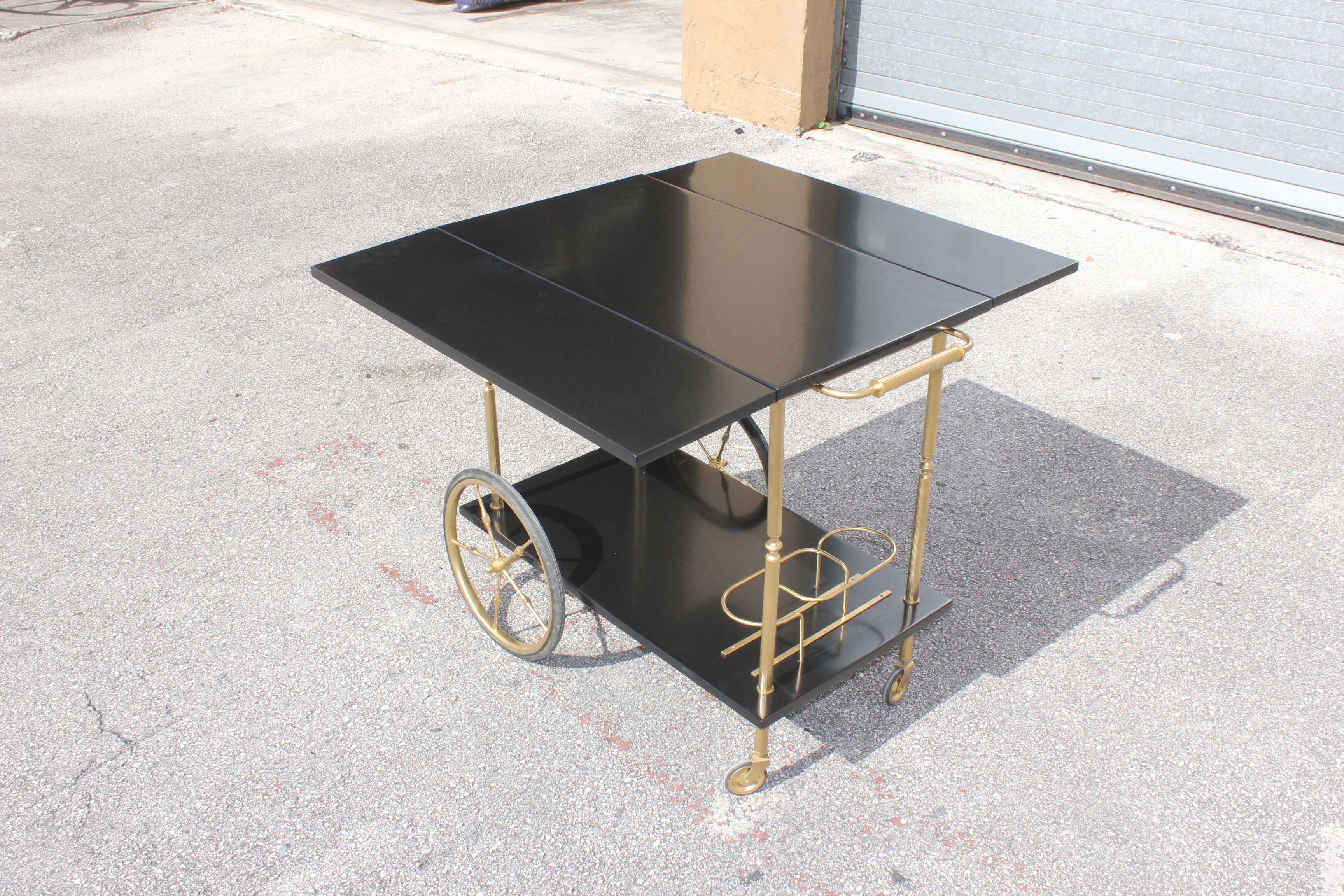 Beautiful Maison Jansen ebonized drop-leaf bar cart with brass details, circa 1940s, Excellent condition. Size: 28 H, 33 W, 19 D. Size: With the leaf open is 34.50. Size: with close leaf is 19 D.