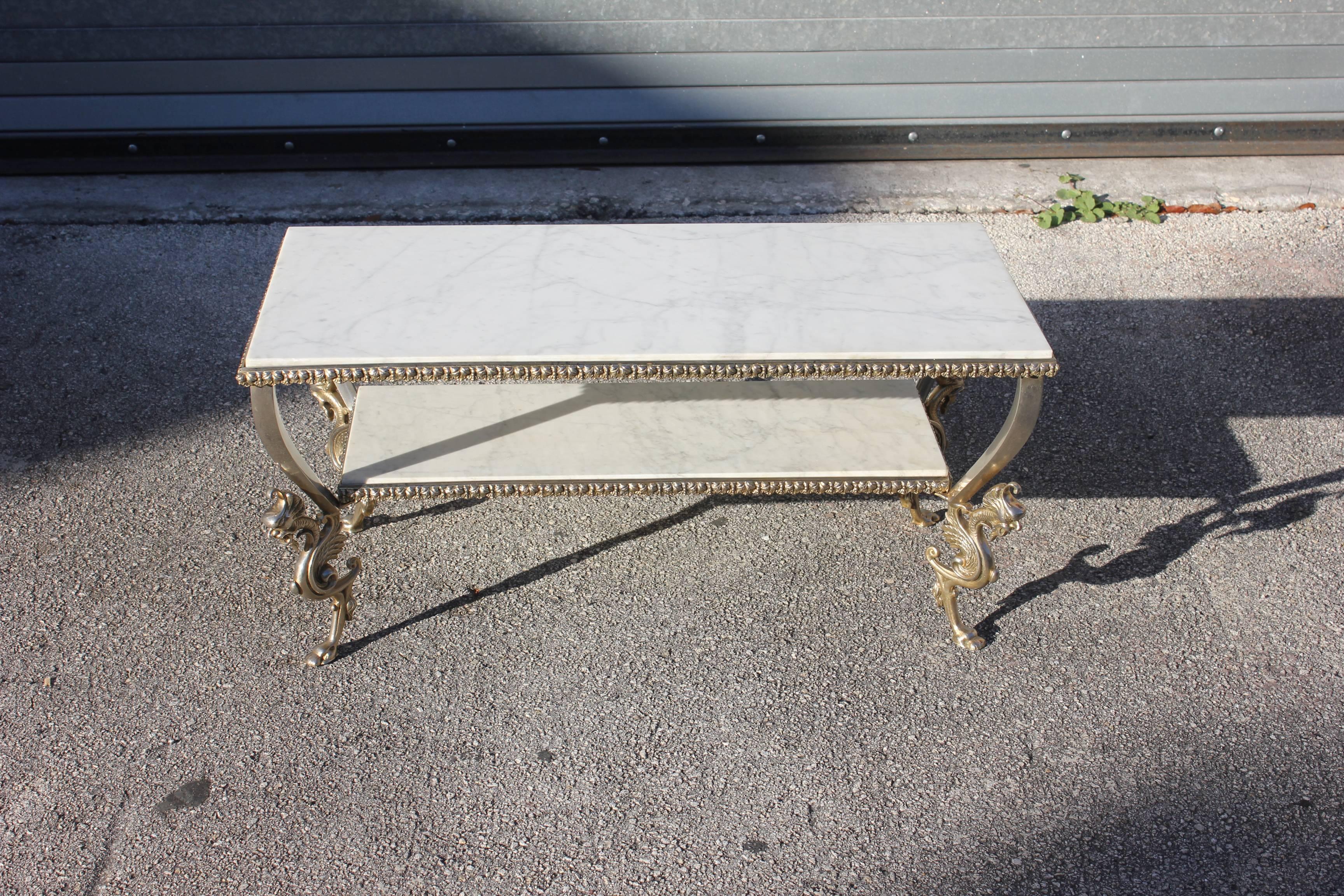 Maison Jansen two-tier bronze '' Dragon Leg'' coffee table with marble top, circa 1940s. Beautiful detail solid bronze with dragon leg and marble, We traveled to buy all our pieces in France .We bought this beautiful coffee table in Paris France, in