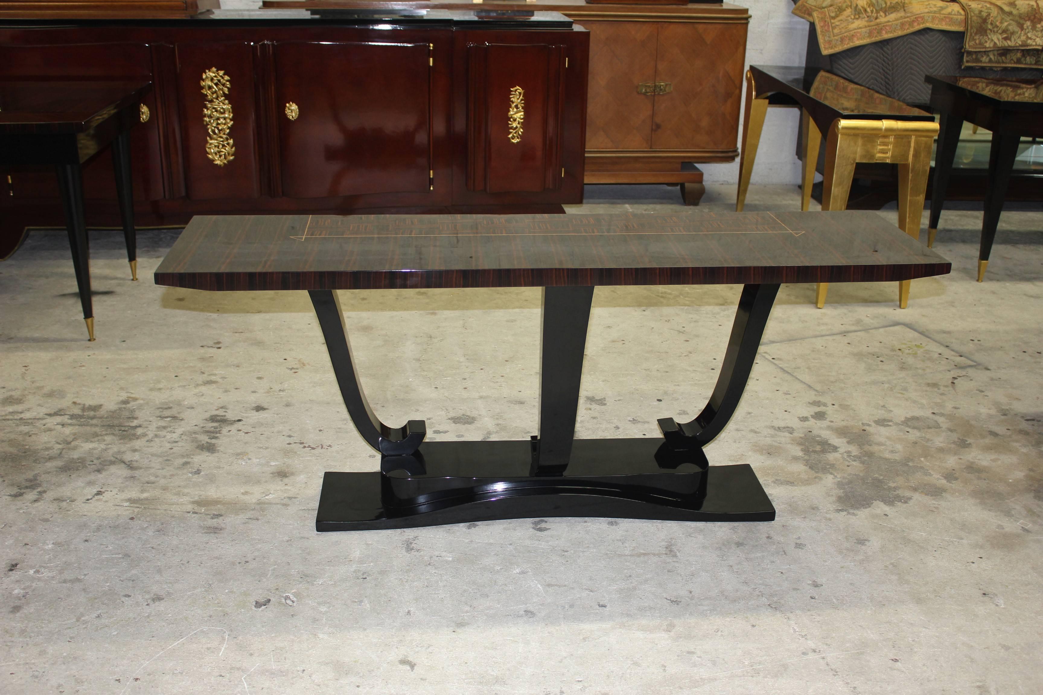 A French Art Deco exotic Macassar ebony console table, circa 1940s. The console table are in perfect condition, three legs ebony ,Macassar ebony top with center inlay parquetry Macassar, beautifully detailed, three legs, steeped base. Please note