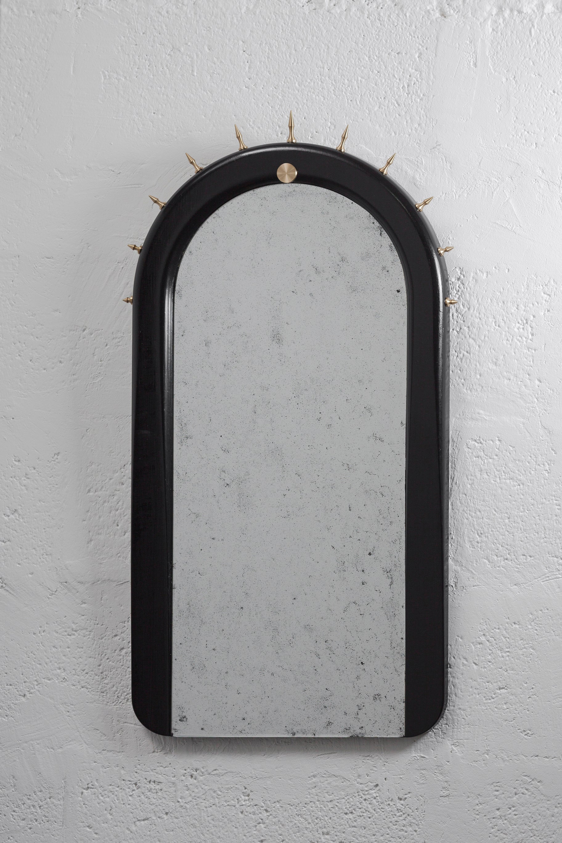 Wall mirror made of solid seike wood body with a natural oil finish, antique mirror glass, and lathed bronze or stainless steel hardware.

The SITIERA_01 wall mirror is an abstraction of the Virgen de Quito crown by Bernardo de Legarda, a Quito