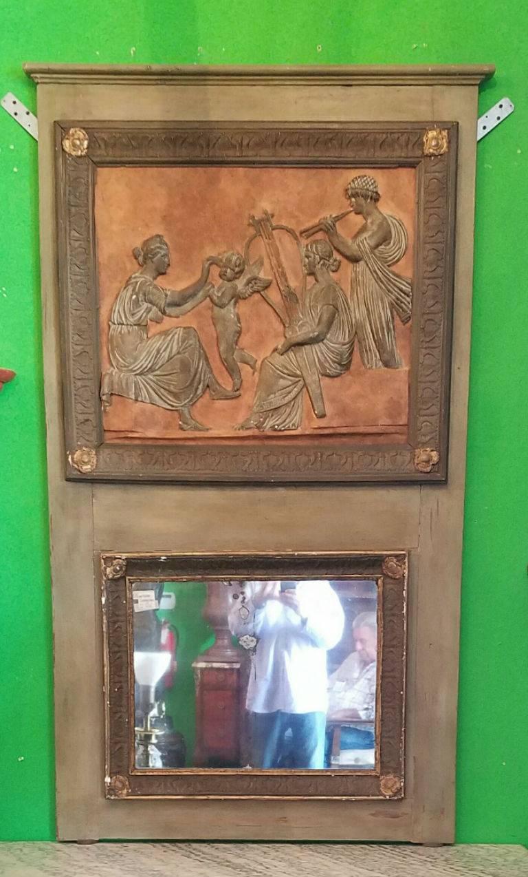 Green painted trumeau mirror; the upper Neoclassical plaque in three-dimensional relief over the original mirror plate. Plaque: 23