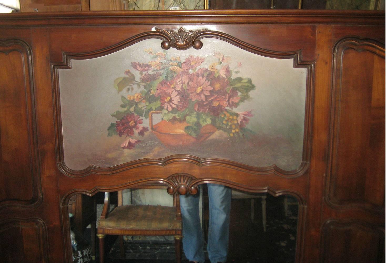 Beautiful Provencial Louis XV carved fruitwood trumeau; the molded cornice above a painting of flowers over a mirror, flanked by carved and molded panels, peg (dowel) construction, the reverse with a Parisian plaque Andre Jules, Versailles.