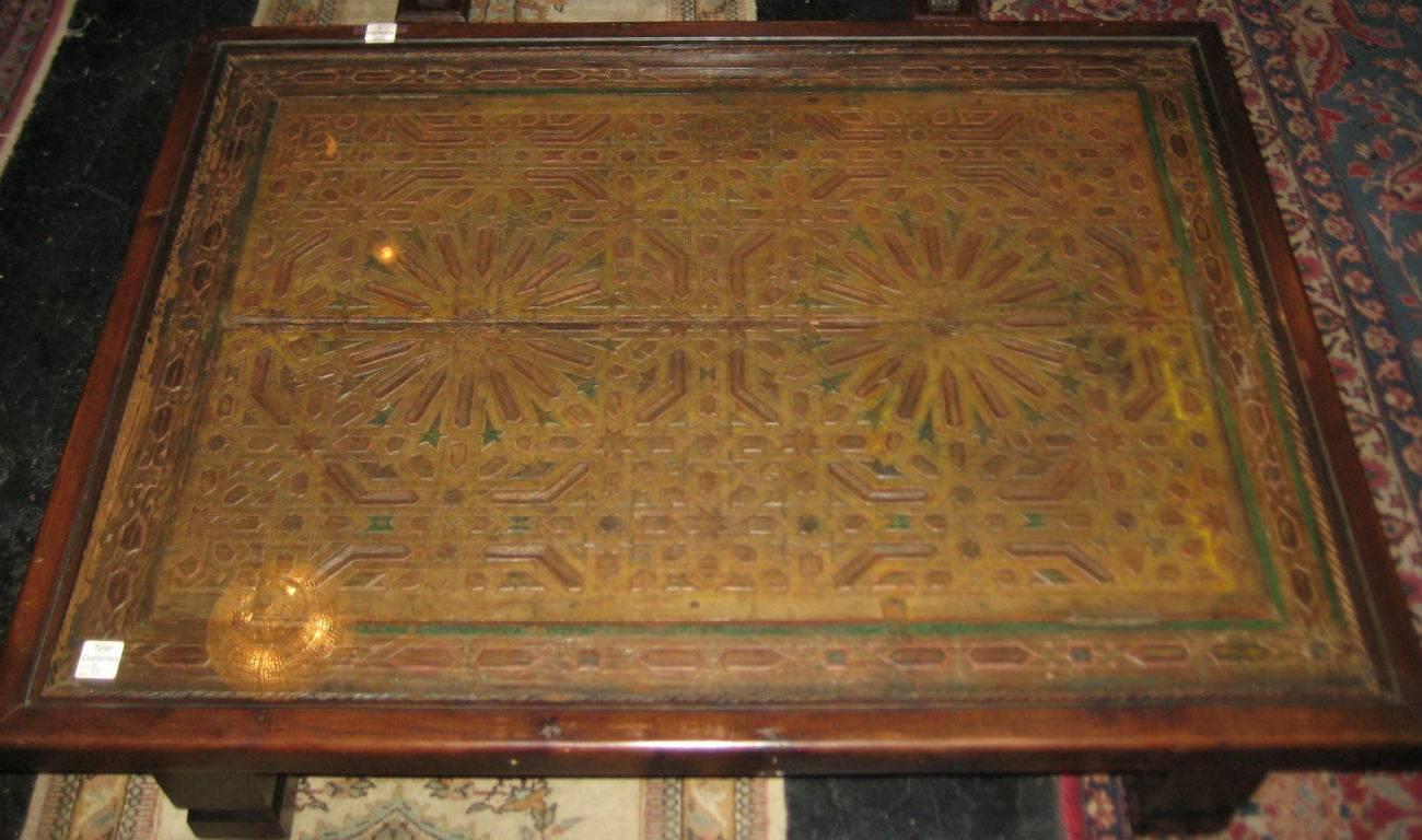 Moroccan carved wood and painted cocktail (coffee) table; the top made from a pair of window panels fitted in a wood frame to make the coffee table with a fitted glass top. H: 18