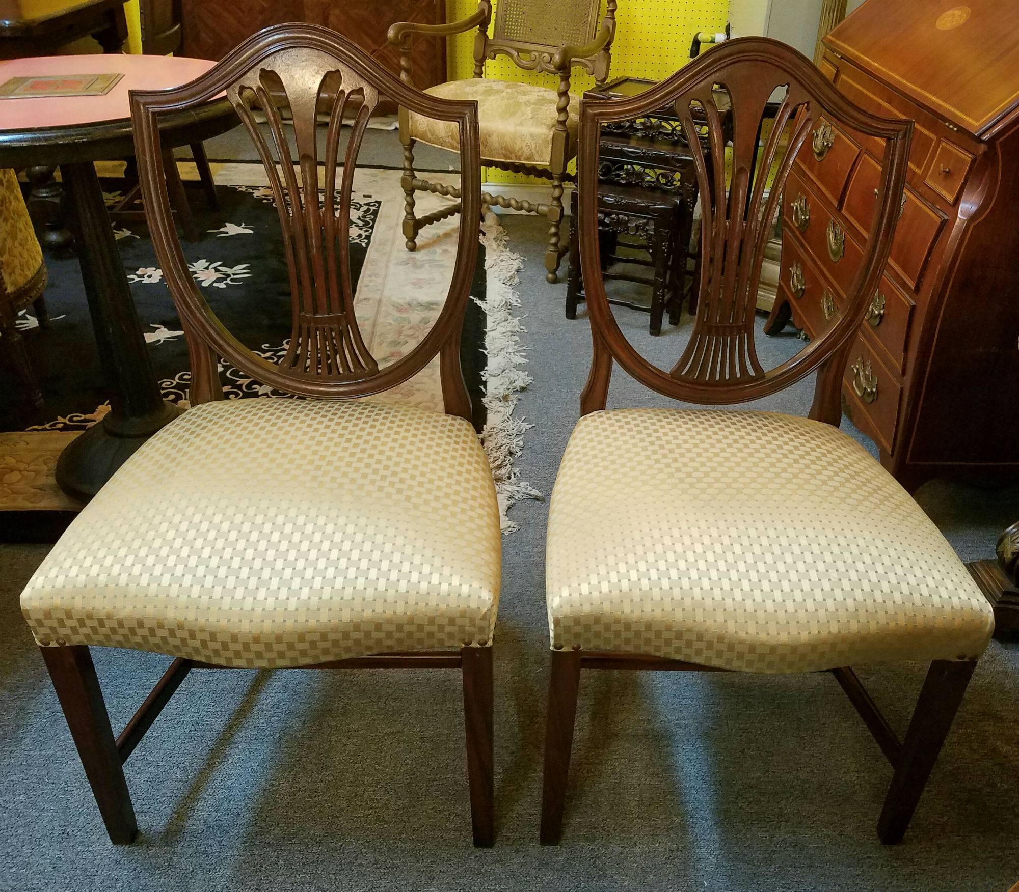 Set of eight Hepplewhite style mahogany shield back dining chairs comprised of two arm and six side chairs.