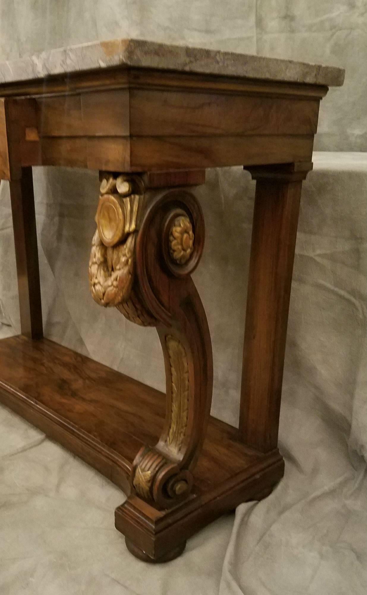 French empire carved rosewood and parcel-gilt marble-top console table with center frieze drawer.