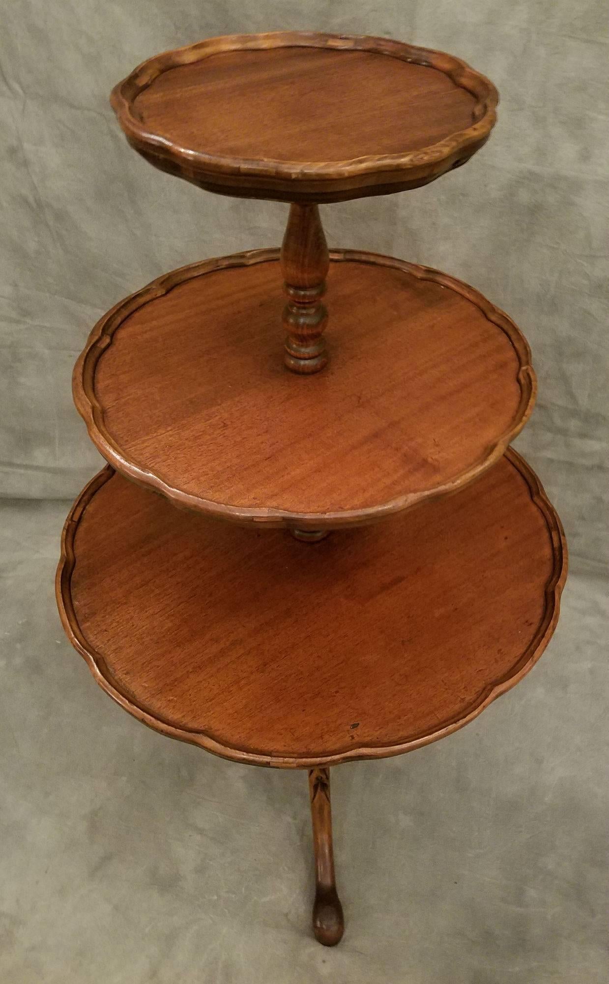Queen Anne mahogany pie crust edge three-tier dumbwaiter on carved legs with snake foot.