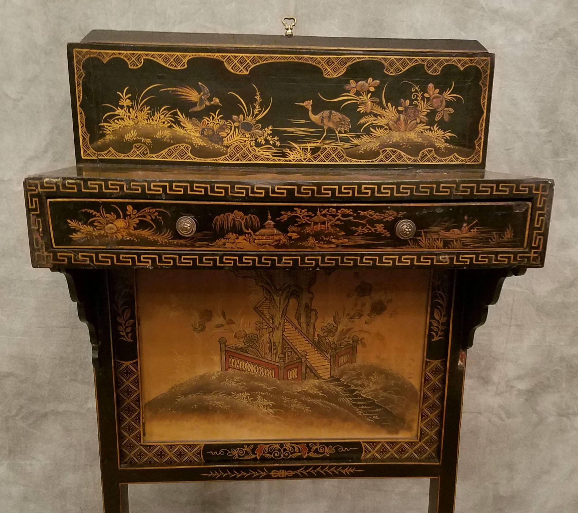 English chinoiserie black lacquer and gilt decorated fireside table or firescreen with a single frieze drawer; the interior of the drawer with a retailer's plaque. With screen extended H: 52