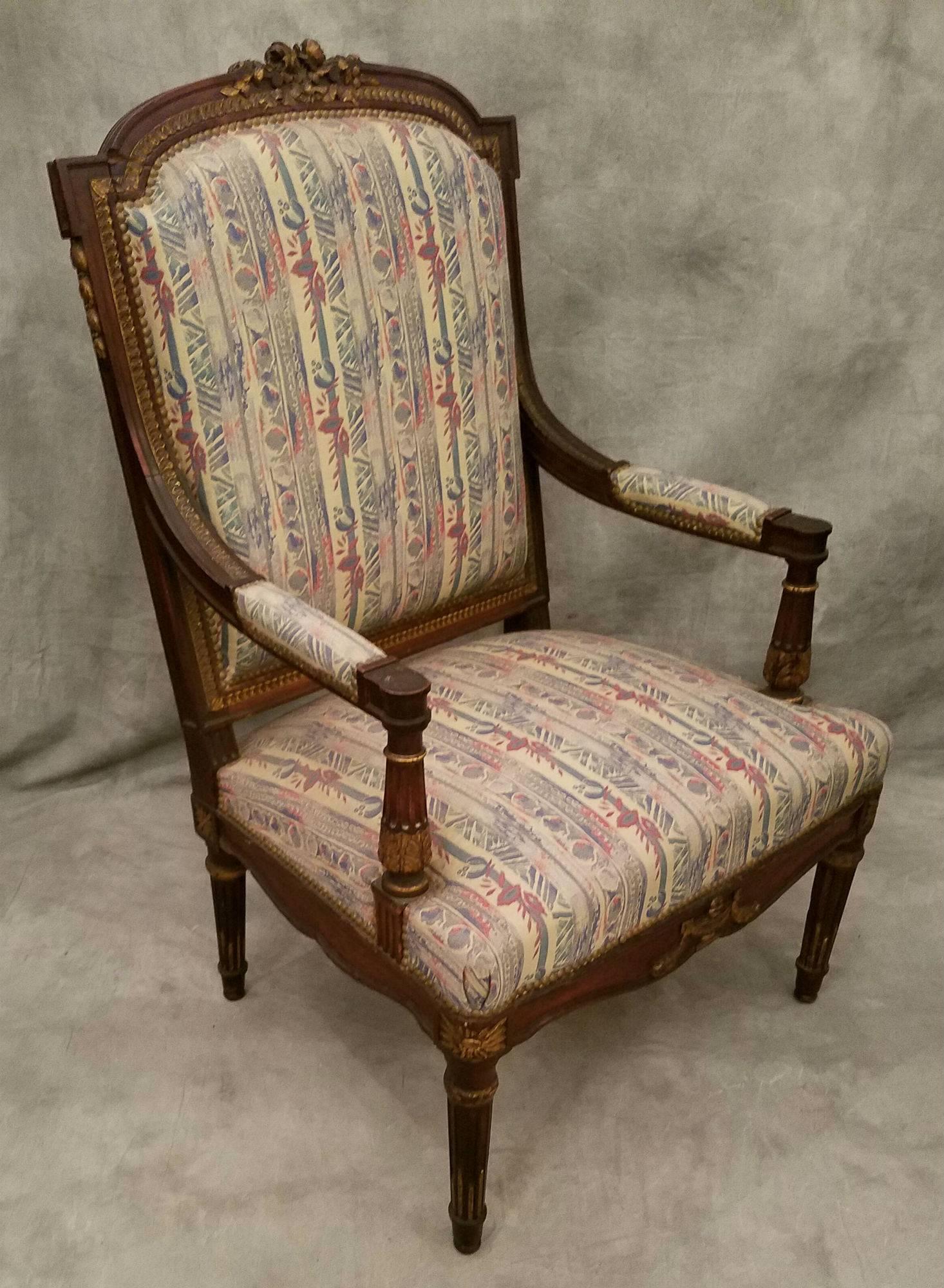 Pair of Louis XVI carved mahogany and partial-gilt fauteuil.