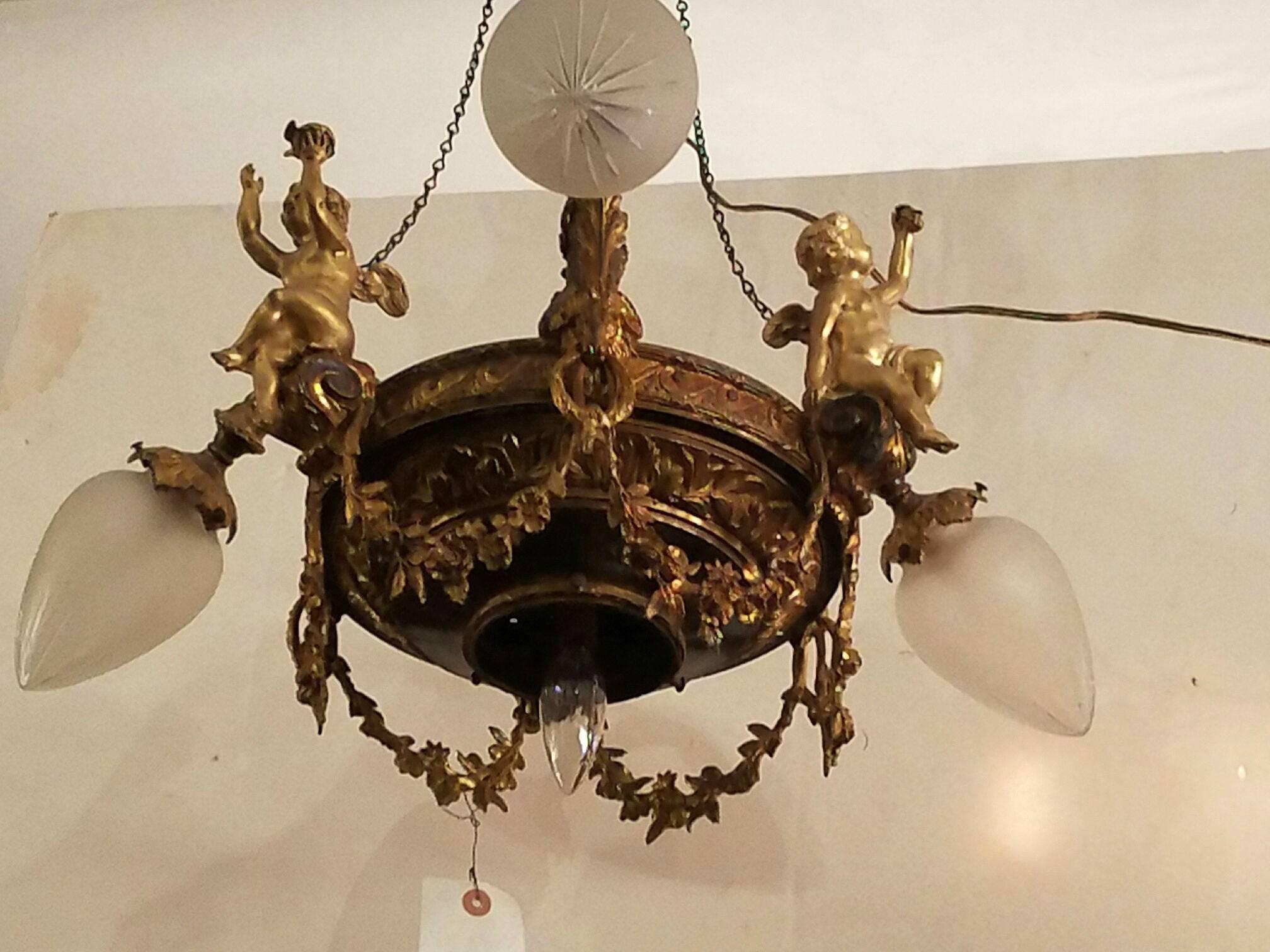 French gilt bronze three branch four-light chandelier with three-seat Cupids and garland swags.