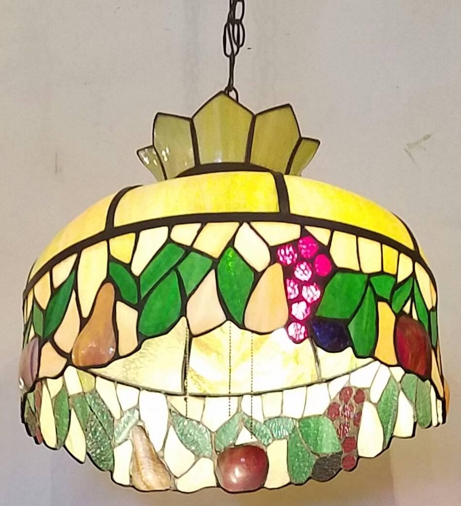Stained and slag glass chandelier with fruit and leaves.