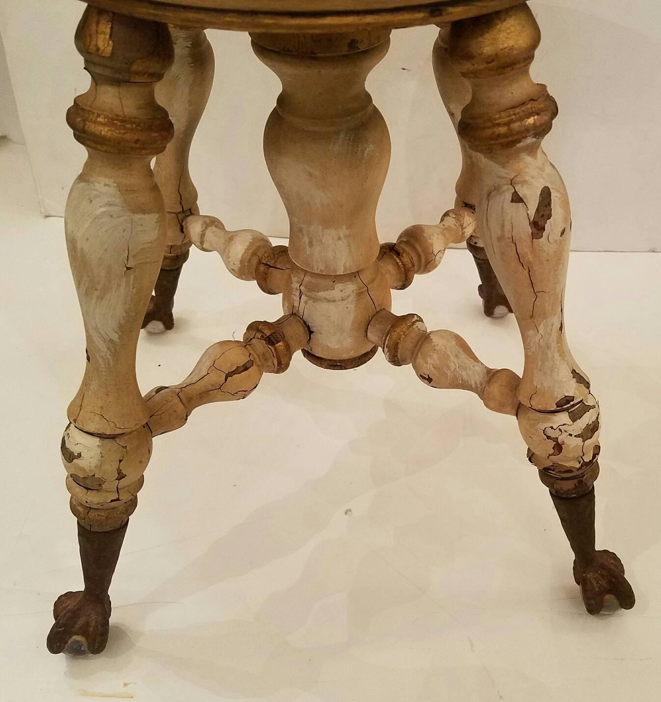 Late Victorian era revolving top piano stool with iron paw and glass ball feet.

Measures: Height 18.25