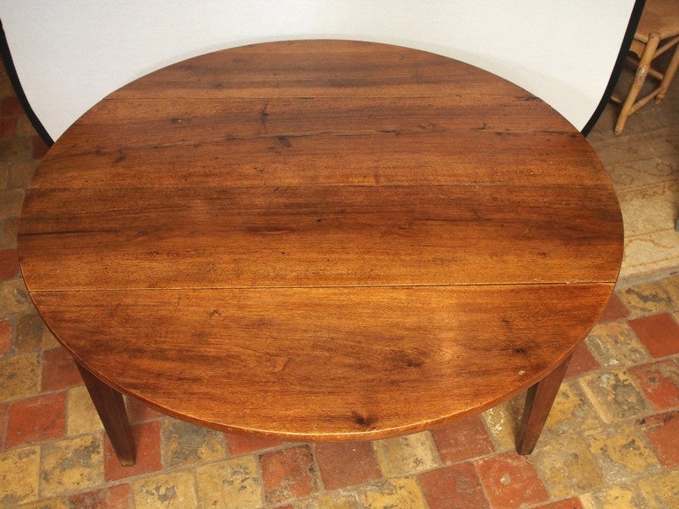 19th century French walnut round drop-leaf table with one drawer from the burgundy area, circa 1820.